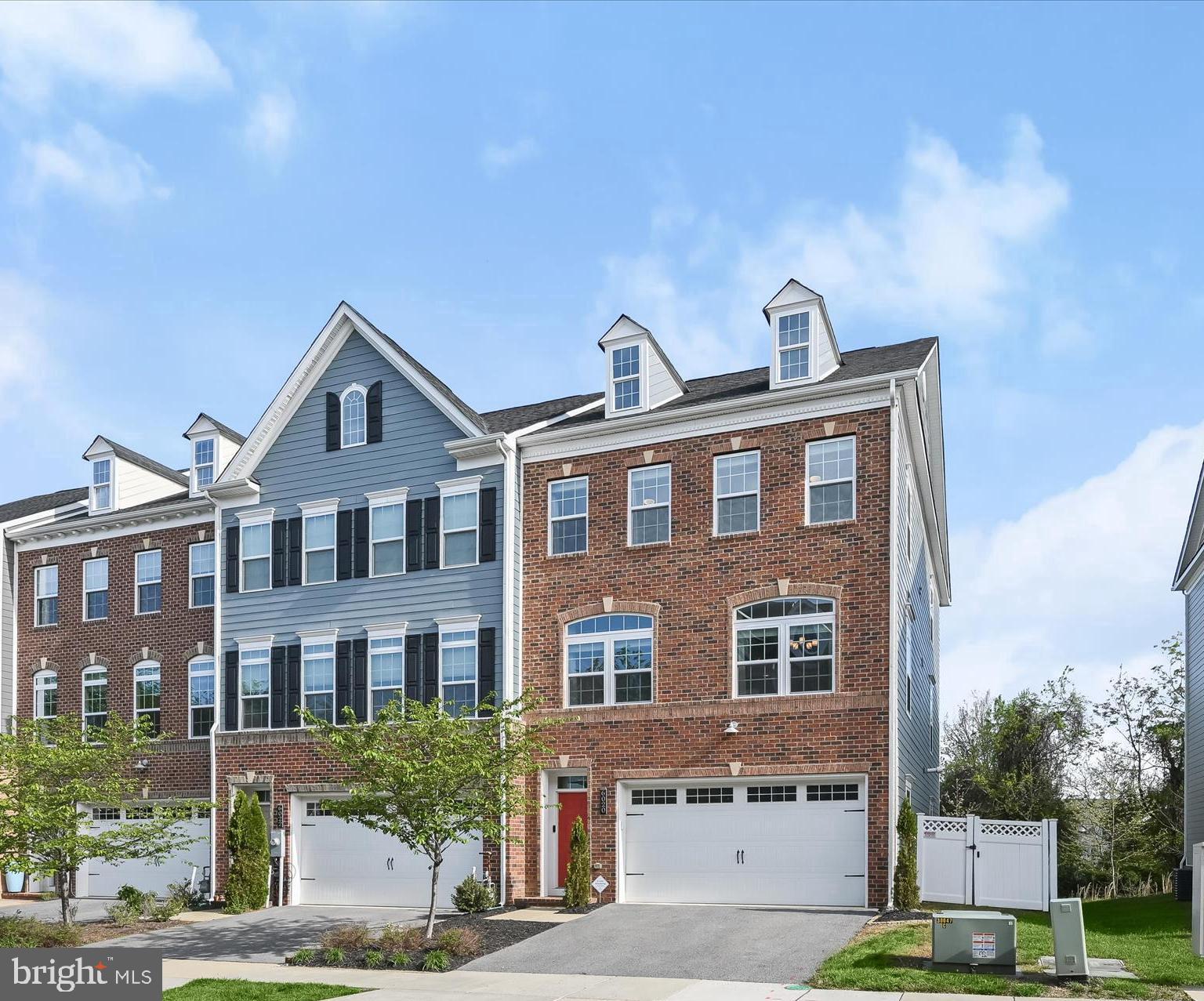 ***Open House on Sunday 1-3 has been cancelled.***   Beautiful end-of-row townhome offering bright, stylish living in a prime location! This sun-filled home features an open floor plan with spacious living and dining areas, enhanced by recessed lighting and wide plank wood floors. The gourmet kitchen is a showstopper—complete with an oversized island, quartz countertops, 42" cabinetry, and a sleek glass subway tile backsplash, perfect for both entertaining and everyday living.  Upstairs, all bedrooms feature updated luxury vinyl plank flooring. The spacious primary suite impresses with vaulted ceilings, a walk-in closet, and a luxurious en suite bath featuring a soaking tub, frameless shower with decorative tile inlay, and a dual granite vanity. Two additional bedrooms, a full bath, and a convenient laundry room complete the upper level.  The lower level offers a large family room with walkout access to a private, fully fenced backyard featuring both a patio and a deck—ideal for outdoor relaxation. A powder room adds extra functionality on this level.   Enjoy fantastic community amenities including a clubhouse, swimming pool, and picnic area. With shopping, dining, entertainment, and major commuter routes all nearby, this home truly has it all!