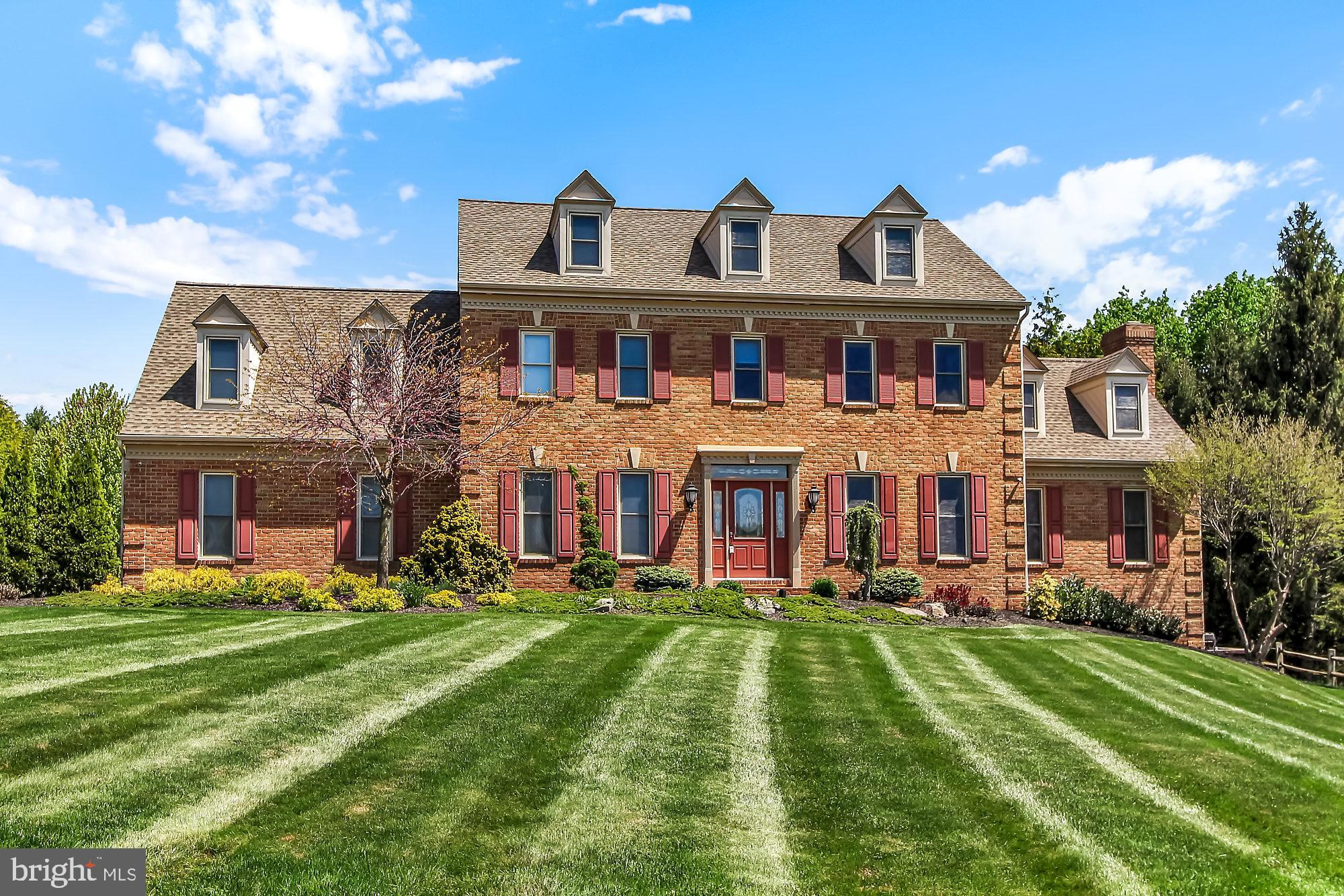 The unmistakable air of elegance is expressed eloquently in this brick 4BR, 3.5BA that looks out onto a picturesque backdrop. The open planning, soaring ceilings, large windows and doors, make the outdoors seem part of the living area. The residence features varied ceiling heights, hardwood floors, columns, French Doors, decorative moldings, 1st floor office, granite kitchen, step-down family room, 1st floor laundry room, luxury master suite with sitting area, vaulted ceiling whirlpool master bath, and a mostly finished lower level with large family room, game room, play room and full bath. Come warmer temperatures, everyone will flock to the fenced backyard, with tiered deck/patio area featuring a retractable awning, overlooking a sparkling 20x40 heated in-ground pool complete with motorized cover. There is also a playset, shed and wall of evergreens for privacy. A finished 3-car end-load garage and large driveway allow for plenty of cars, toys and storage. AGENTS - Please read Agent Remarks!