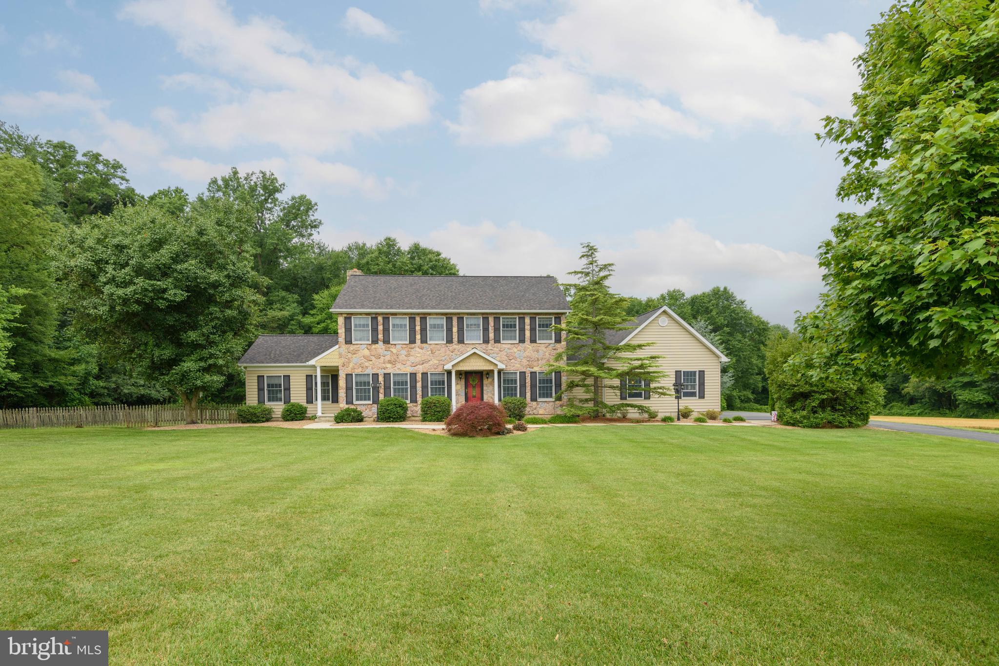 79 Fairview Road, Elkton, MD

Nestled on a breathtaking 6.2-acre homesite surrounded by rolling countryside, mature woods, and open space, this meticulously maintained custom Colonial offers approximately 5,000 square feet of beautifully finished living space, including approximately 1,740 square feet of finished walk-out lower level, a remarkable private in-law residence, and exceptional outdoor amenities.

A welcoming center hall with a slate foyer and elegant open staircase sets the tone for this thoughtfully designed home. Rich hardwood flooring extends throughout much of the main level, where 9-foot ceilings enhance the spacious feel. The formal dining room is accented with crown molding, while the inviting family room features a floor-to-ceiling brick fireplace with a custom mantel. Sliding doors open to a spectacular screened porch overlooking the private rear grounds.

The gourmet kitchen is beautifully appointed with cherry cabinetry, granite countertops, tile backsplash, stainless steel appliances, a Bosch dishwasher, and abundant workspace, making it ideal for both everyday living and entertaining. A first-floor laundry room with ample storage, utility sink, and exterior access provides added convenience.

A True Private In-Law Residence
One of the home's most exceptional features is its fully equipped first-floor in-law suite with its own private entrance, offering independence while remaining connected to the main residence. This outstanding space includes:

Spacious 18' x 13' living room
Full 8' x 14' kitchen
Generous 15' x 19' bedroom
Full bathroom with dedicated laundry area
Perfect for multigenerational living, extended family, long-term guests, live-in caregivers, or even a private home office.

The second floor offers an inviting owner's suite complete with hardwood flooring, an adjoining sitting room, and a beautifully updated spa-inspired bath featuring heated tile floors and a walk-in tiled shower. Two additional bedrooms share a renovated hall bath with heated tile flooring and a classic cast-iron soaking tub.

The finished walk-out lower level is designed for entertaining and recreation, offering a spacious family room, wet bar with wine refrigerator, exercise area, full bath, and abundant storage.

Step outside to your own private resort. The screened porch, expansive patio, and sparkling 18' x 36' saltwater in-ground pool create the perfect setting for relaxing or entertaining family and friends. The pool features a 500-square-foot paver patio and overlooks peaceful open space and mature trees, providing an exceptional backdrop for outdoor living.

Additional highlights include:

5 Bedrooms | 4½ Bathrooms
Three-car oversized attached garage with attic storage
Whole-house generator
400-amp electrical service
Propane forced-air furnace serving the entire home
Central air conditioning for the first and second floors, plus a dedicated second-floor heat pump providing additional heating and cooling
Beautiful hardwood flooring
Quality 2x6 construction throughout
Meticulously maintained inside and out
Picturesque 6.2-acre setting offering outstanding privacy
This is a rare opportunity to own a quality-built country estate that perfectly blends elegance, comfort, and versatility while offering an exceptional private setting just minutes from town.