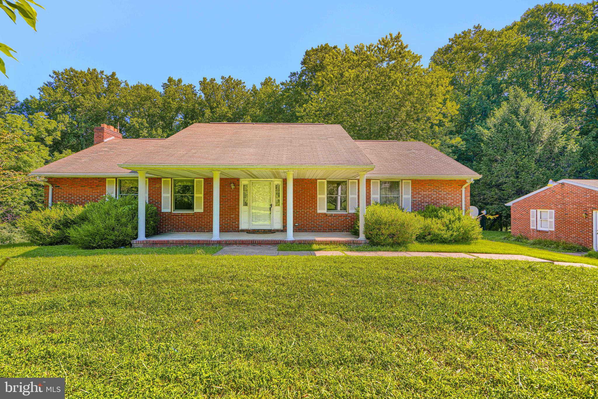 AGENTS - PLEASE VIEW AGENT REMARKS IN BRIGHT MLS.
****Rarely does a property offer this exceptional combination of space, privacy, acreage, and value in sought-after Marriottsville MD.**** Nestled on 3.83 private acres and tucked well back from the road, this all-brick rancher offers the perfect blend of peaceful country living and everyday convenience, just minutes from shopping, dining, parks, and major commuter routes.  A charming covered front porch spans the entire front of the home, creating a warm welcome and inviting place to relax. Inside, you'll find true one-level living with a spacious, light-filled living room enhanced by Andersen windows. The formal dining room features elegant French doors that open to the covered rear porch, where you can enjoy tranquil views of the private, tree-lined backyard. The dining room flows seamlessly into the beautifully appointed kitchen, complete with rich walnut cabinetry, granite countertops, tile backsplash, stainless steel appliances, and a sunny breakfast area and a pantry.  The spacious primary suite includes a private en-suite bath featuring a jetted soaking tub, ample closet space, with French doors opening to the fully covered back porch. While two additional generously sized bedrooms and a second full bath complete the main level. The expansive finished walk-out lower level offers incredible versatility with a large family room anchored by a cozy wood-burning fireplace, an impressive 12-foot wet bar, a bonus room, dedicated office with 2 large closets, full bath, and a beautifully finished paneled alcove that is ideal for a game room, reading nook, or hobby space. A separate laundry room with washer and dryer (2024), abundant storage space, and central vacuum add to the home's convenience. Need even more space? A fully floored, insulated walk-up attic with skylights provides exceptional storage and offers exciting possibilities for future expansion. Recent updates include a heat pump (2021), hot water heater (2024), washer and dryer (2024), microwave (approximately three years old), and a reverse osmosis water treatment system, providing peace of mind for years to come. Car enthusiasts, hobbyists, and outdoor enthusiasts will appreciate the oversized three-car garage and long paved driveway, offering abundant parking for vehicles, equipment, RVs, boats, or recreational toys. Backing to Liberty Reservoir, this remarkable property offers a rare opportunity to enjoy unmatched privacy, scenic natural surroundings, and endless possibilities, all while remaining conveniently close to modern amenities. If you've been searching for room to spread out in one of Carroll County's most desirable locations, this exceptional property is ready to welcome you home!

AT SELLER'S DISCRETION, AN OFFER MAY BE ACCEPTED AT ANY TIME.