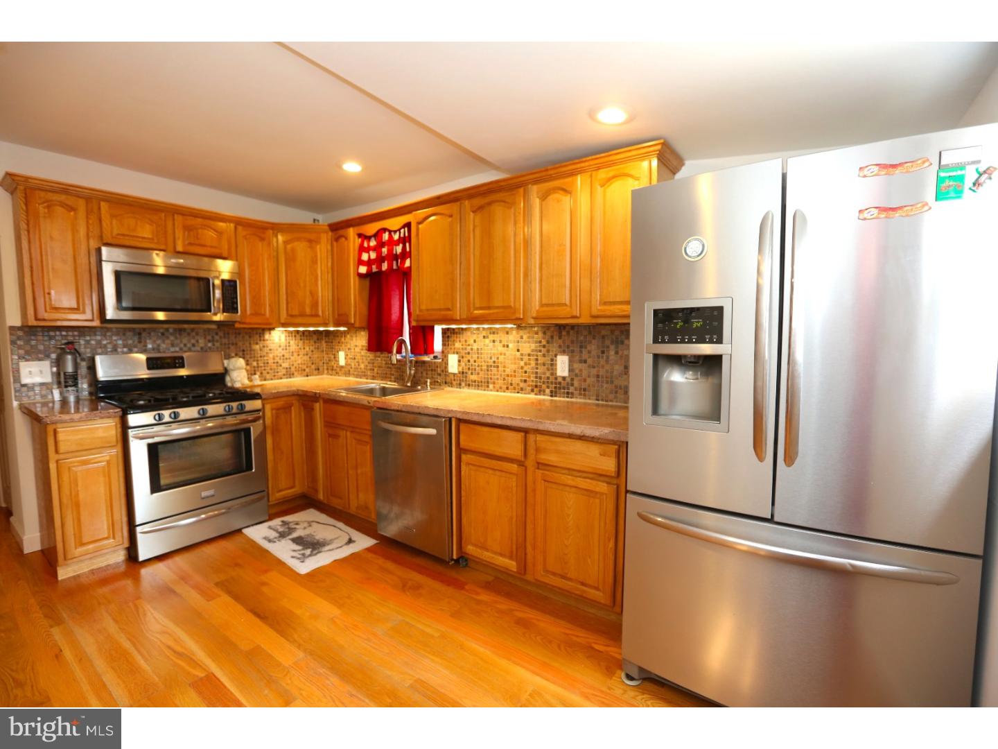 Incredibly charming inside and out! This 2-story brick front with original cornice, 2 large bedrooms and 1 spacious bath sits on one of the best blocks in Fishtown and is available immediately.  Enter into a open living and dining room with exposed brick, 2 ceiling fans, and plenty of room for furnishings with the modern and open layout. There are hardwood floors and recessed lights throughout. The kitchen has a mosaic back splash, granite counters and a full stainless steel appliance package. There is a large rear yard accessible through the kitchen making grill to table service a breeze and perfect for pets and/or landscaping. The 2nd floor bedrooms are ample size and the hall bath is beautiful with a decorative solid wood vanity with granite top with oiled bronze glass shower enclosure and soaking tub and modern tile throughout. This home has both central air and radiator heating and is tastefully updated throughout.  We welcome your visit today!