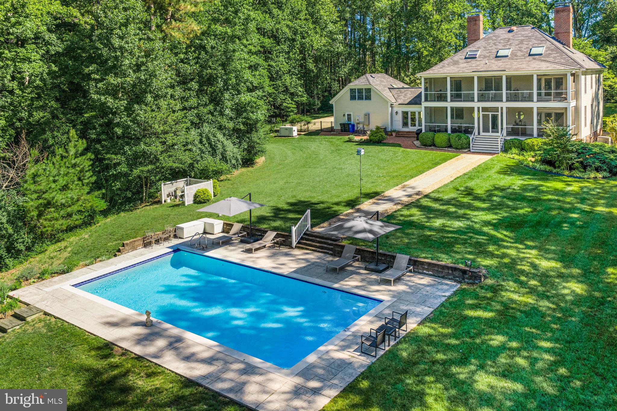 Tucked away on 5+ private waterfront acres, this exceptional 4,743-square-foot estate blends timeless architecture with an extraordinary Chesapeake Bay lifestyle. The main residence features four bedrooms, three-and-a-half baths, gracious formal living and dining rooms, a warm family room, four fireplaces, a beautifully renovated designer kitchen with breakfast area, and a luxurious primary suite with private office, fireplace, and separate his-and-her baths. A spacious third-floor bonus room offers endless flexibility. A charming mudroom and breezeway connect the home to an oversized two-car garage and a private apartment with its own entrance from the breezeway. Complete with a sitting area, breakfast bar, refrigerator, bedroom, and ensuite bath, it's ideal for guests or extended family. Outdoor living is equally impressive with double screened porches overlooking the water, a beautifully replastered heated pool, a private pier with electricity, water, lighting, and a 10,000-pound boat lift, plus a separate floating dock for kayaks and paddleboards. Protected water offers quick access to the Corrotoman and Rappahannock Rivers. Lovingly maintained as both a private family retreat and a highly successful luxury vacation rental, the property is offered fully furnished (with limited exclusions), creating a truly turnkey opportunity to enjoy immediately or continue its proven rental success. A whole-house generator, oversized garage with workshop, waterfront firepit, fenced backyard, brick patio, and beautifully landscaped grounds complete this exceptional offering.