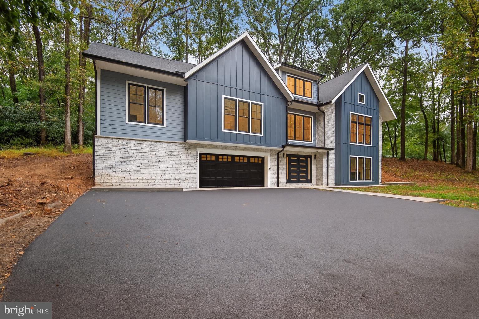 A totally rebuilt, Move-In Ready Home with Pond Views on a 2.71 Acre Corner Lot

Set on a picturesque 2.71 acre corner lot with views of a semi-private pond, this property blends the beauty of an established setting with the benefits of a brand-new home. Stripped to its foundation and original fireplace, the residence has been completely rebuilt from the ground up. Every system and finish—including framing, walls, plumbing, electrical, water heater, and well—is brand new, ensuring peace of mind for years to come.

Inside, a spacious lower-level foyer highlighted by a statement circular chandelier sets the tone for the light-filled layout. Upstairs, the open-concept living and dining room flows seamlessly into a chef’s kitchen featuring illuminated luxury cabinetry, GE Café Series appliances, and an approx. 43 sqft island with seating—an ideal centerpiece for entertaining.

The upper level hosts a serene primary suite with a spa-inspired bath, plus three additional bedrooms: two joined by a Jack-and-Jill bath and one with its own en-suite. The lower level extends the living space with a large family room anchored by the original wood-burning fireplace, a private office, full-size laundry, and generous storage—including bonus space off the garage.

Combining energy-efficient systems, turnkey finishes, and timeless character, this home offers flexible spaces for work and play, low-maintenance living, and peaceful pond views. It’s the perfect blend of modern comfort and natural beauty, ready for its next chapter.