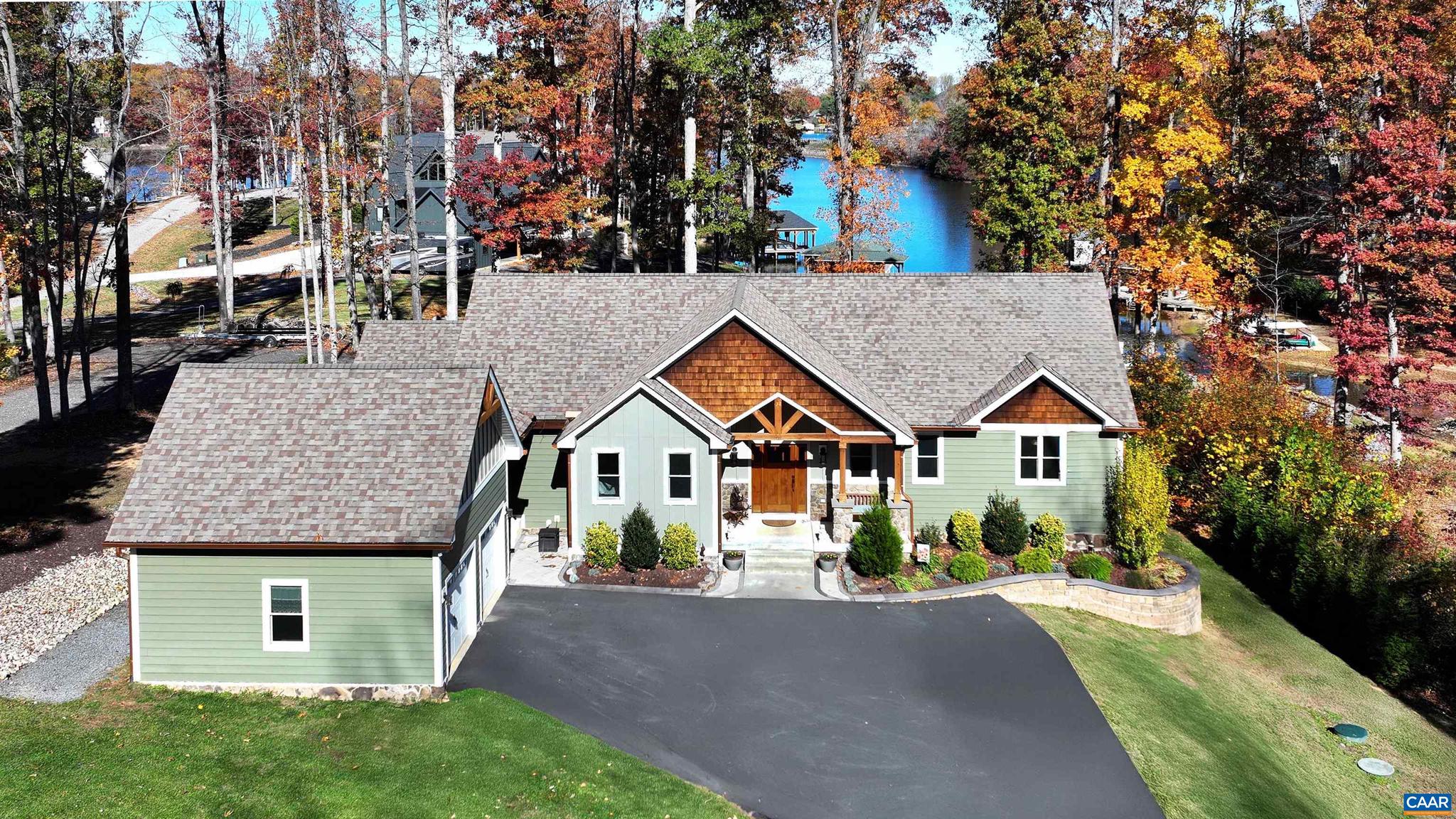 NEW PRICE. Welcome to Lighthouse Point, where luxury meets lakefront living on the private side of Lake Anna. This exceptional custom home offers a lifestyle you simply won?t find anywhere else. "Ultimate Private Sanctuary". Beautifully landscaped lot with deep-water access, 170' water front, 2-slip boathouse w/2 jet ski ramps, storage closet, screen porch, 2 sitting areas, shower, beach area -everything you need for endless days on the water. Inside, this 5-bedroom, 3 bath lakefront masterpiece spans approx 3,700 square feet of thoughtfully designed living space. Step inside to discover soaring ceilings, hardwood floors, and expansive lake views that fill the home with natural light. The gourmet kitchen is a true showstopper?featuring high-end appliances, quartz counters, custom cabinetry, and designer finishes that make it both functional and stunning. The open-concept living area is anchored by a stone gas fireplace, creating a warm and inviting atmosphere perfect for entertaining or relaxing with family. Enjoy the outdoors year-round on the covered, screened-in porch with breathtaking lake viewS. Attached 2 car garage and detached 2 car garage, hot tub, generator. CAN BE SOLD FURNISHED IF DESIRED!,Maple Cabinets,Quartz Counter,Fireplace in Living Room