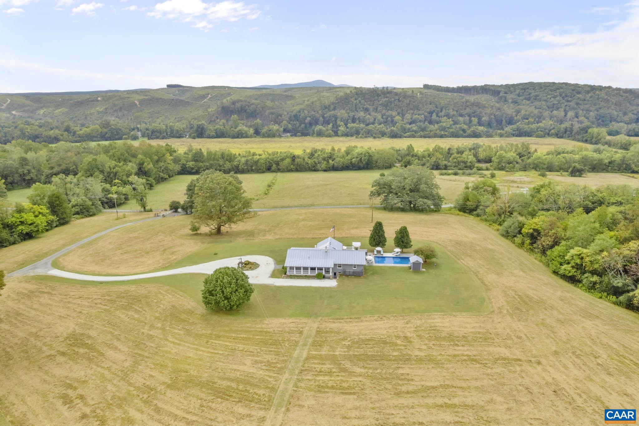 Robbin?s Nest Farm spans 212 acres with over 1/3 mile of James River frontage, offering a rare blend of natural beauty, income potential. and modern comfort. The main 3-bedroom plus lower level rec room and bonus/flex room residence features inviting living spaces, a sunroom, pool, and hot tub. Two additional homes?the historic brick guest house and a guest cottage attached to the stables?provide versatile options for short- or long-term rental income or farm manager. The farm is well-equipped for equestrian pursuits with a 14-stall stable, hay barn, and 4,000 sq. ft. concrete floor equipment shed. Fertile bottomlands, fenced pastures, rolling hayfields, 4 horse/RV trailer hook-ups, and wooded areas create endless possibilities for farming, livestock, or recreation. Private trails wind through the property, one of which leading to the James River with its private boat ramp and beach affording opportunities for excellent fishing, paddling, or quiet reflection. Whether envisioned as a working farm, sporting retreat, or private estate with built-in hospitality potential, Robbin?s Nest Farm offers scale, versatility, and unmatched river access.,Granite Counter,Fireplace in Family Room