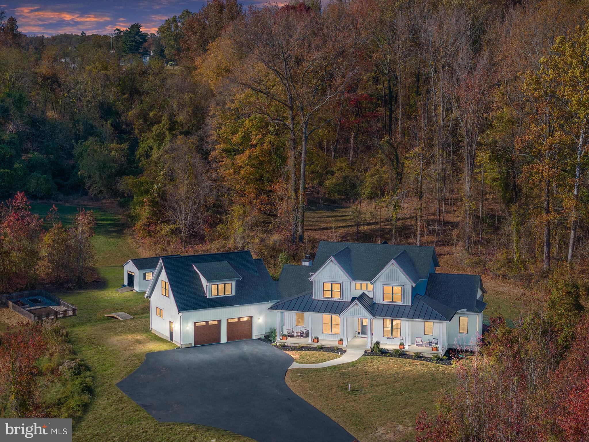 Set on 8 sprawling acres in the prestigious Governors Crossing community, 3910 Jiggsy Court in Edgewater, MD is more than just a home—it’s a statement of unparalleled luxury and exquisite living. From the moment you arrive via the sweeping private driveway, the grandeur of this 2020 custom-built farmhouse craftsman takes your breath away. The stately full front porch invites you to pause and take in the serenity of this exclusive estate before stepping into a sun-drenched haven of sophistication and style. Inside, soaring ceilings, walls of windows, and bespoke finishes create an atmosphere of refined elegance. At the heart of the home lies a gourmet kitchen that’s nothing short of a chef’s fantasy, complete with gleaming white maple cabinetry, quartz countertops, top-of-the-line stainless steel appliances, a wet bar, wine fridge, double wall oven, three dishwashers, and an expansive walk-in pantry. Whether hosting grand soirees or intimate gatherings, this kitchen is where culinary dreams and cherished memories come to life. The first-floor primary suite is a sanctuary of indulgence, offering a spa-inspired bathroom with a glass-enclosed rain shower, a soaking tub, and double vanity, as well as direct access to a backyard paradise. Outside, your private resort awaits—a heated saltwater pool with a retractable cover and cascading waterfalls, tiered patios, and a wood-burning fireplace that set the stage for unforgettable moments, from poolside summer soirees to cozy winter evenings under the stars. Upstairs, four spacious bedrooms and a luxurious aupair/in-law suite with its own kitchenette and private living area provide room for everyone, while the fully finished lower level is an entertainer’s dream. Here, a rec room, billiard room, full bar, gym, craft room, safe room, and cozy den ensure there’s space for every passion and occasion. As if the interiors weren’t captivating enough, the outdoor space elevates this home to a league of its own—imagine hosting glamorous gatherings, roasting marshmallows by the fire, or simply soaking in the tranquility of the surrounding natural beauty. Perfectly blending elegance with livability and designed for those who refuse to settle for ordinary, 3910 Jiggsy Court isn’t just a home—it’s a lifestyle, a masterpiece, and a once-in-a-lifetime opportunity to claim your dream. Don’t let this jewel slip away—schedule your private tour today and experience the magic for yourself.