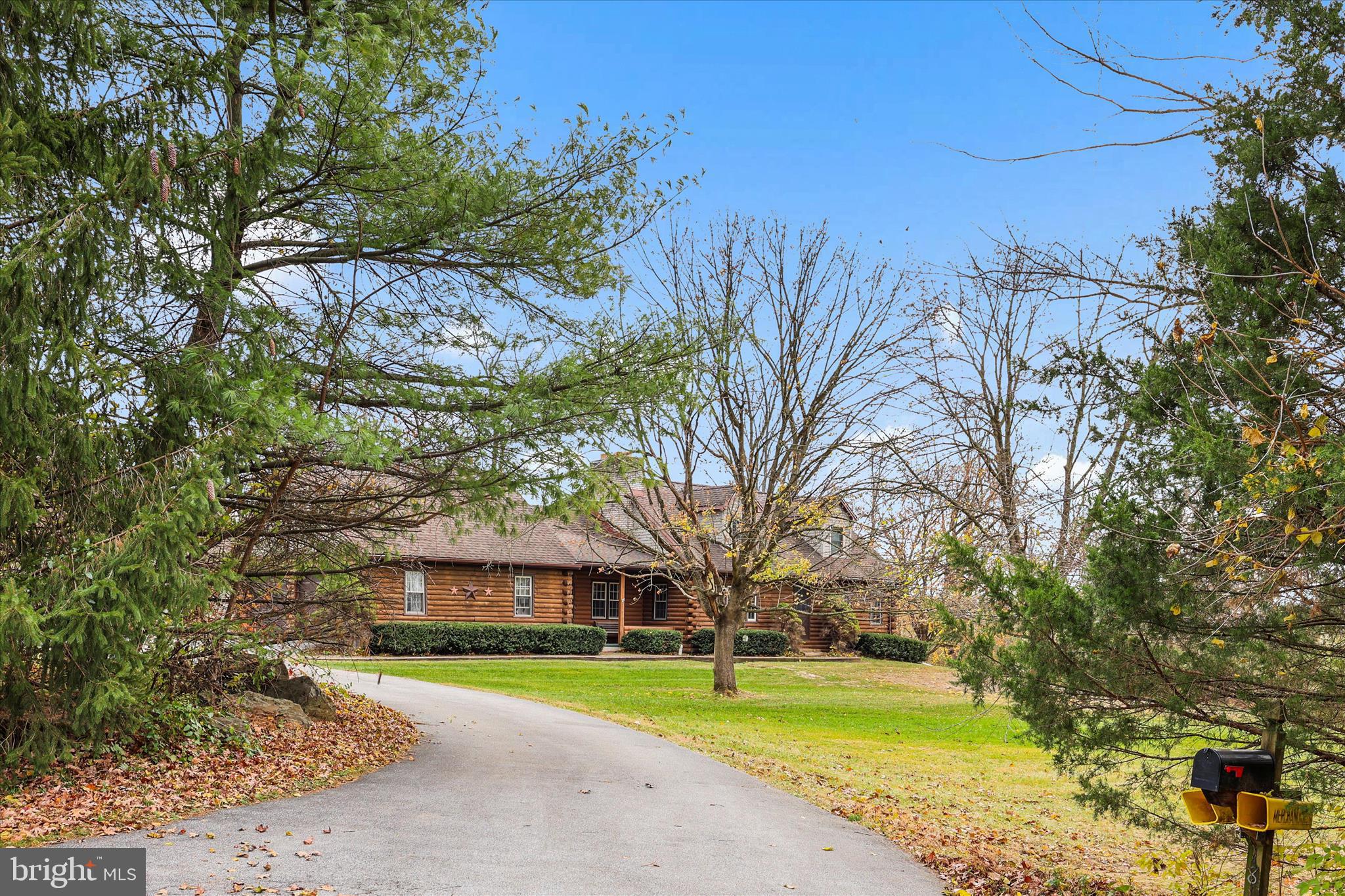 Welcome to your country retreat! This beautiful log cabin–style home sits on 4.44 private acres and features 3 to 4 bedrooms and 2 full baths, including a private second-floor oversized primary suite with electric fireplace. The kitchen and dining area boasts a cathedral ceiling and a wood-burning fireplace, while the family room showcases exposed wood beams and another wood-burning fireplace.  Enjoy plenty of garage space with an attached 2-car garage plus a 3-car detached garage offering even more space for storage or a workshop. Experience the perfect blend of rustic character, comfort, and privacy—all in a peaceful country setting close to local conveniences.