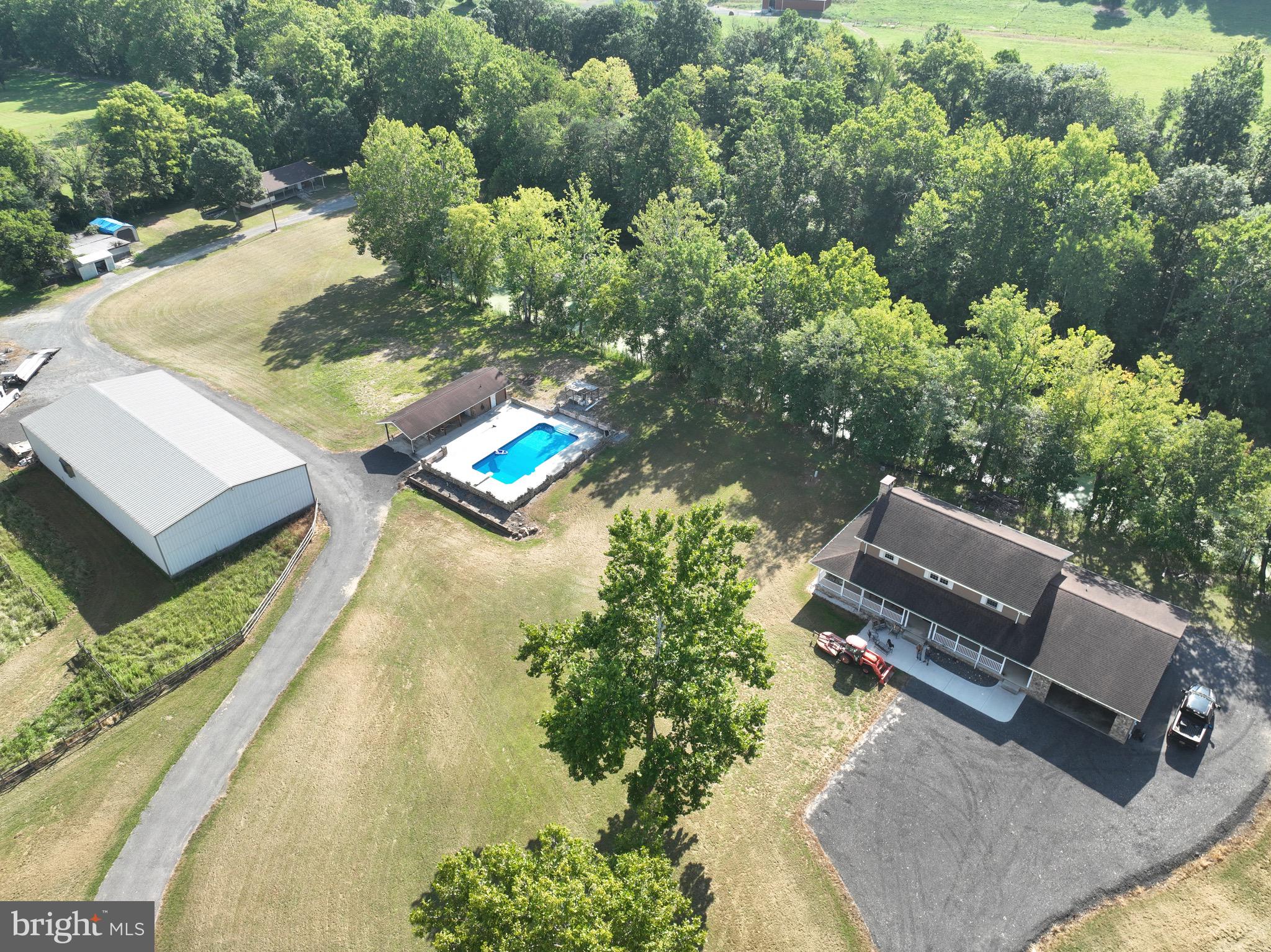 Nestled in the hills of northern Allegany County, this one‑of‑a‑kind country estate offers over 63 acres of pure Western Maryland beauty. Located in peaceful Ellerslie, this custom‑built home—constructed in 1996 and boasting more than 5,000 sq. ft. including the basement—invites you to bring your vision and transform it into the mountain retreat of your dreams. The property is being sold AS IS, making it the perfect blank canvas for a buyer with imagination and ambition.

Step onto the grounds and you’ll immediately feel the possibilities. The estate includes an impressive 50' x 100' insulated steel building, a barn with 6 stables, water and electric, a horse riding ring, and extensive fencing—ideal for equestrians, hobby farmers, or anyone seeking space for animals or equipment. A separate tenant house is currently being refreshed and offers potential rental income, guest accommodations, or additional storage.

Behind the home, a 4‑acre pond provides a serene setting for fishing, wildlife watching, or simply unwinding at the water’s edge. Wills Creek borders the eastern side of the property, adding even more natural charm. For those who prefer a touch of luxury, enjoy the in‑ground pool, complete with a pool house featuring a full kitchen, bathroom, and outdoor bar—perfect for entertaining or relaxing in total privacy.

The land itself offers approximately 10 acres of pasture, suitable for livestock or easily converted back to farmland. Outdoor enthusiasts will appreciate the abundant wildlife—deer, turkey, and more roam freely across the property, offering exceptional hunting right in your backyard. Several pieces of equipment, including ATVs and farm machinery, are also available for purchase.

Despite its seclusion, the property is just 15 minutes from Cumberland, the Pennsylvania line, and Interstate 68—giving you the perfect blend of privacy and convenience.

This is truly a rare offering in Western Maryland—a sprawling estate with unmatched potential, stunning natural features, and amenities you won’t find anywhere else in the region. With a little TLC, this mountain property can become an extraordinary legacy home or recreational haven.

SELLER FINANCING PREFERRED WITH 25% DOWN—contact for details.  
Don’t miss your chance to own this remarkable piece of the mountains. Schedule your private tour today.