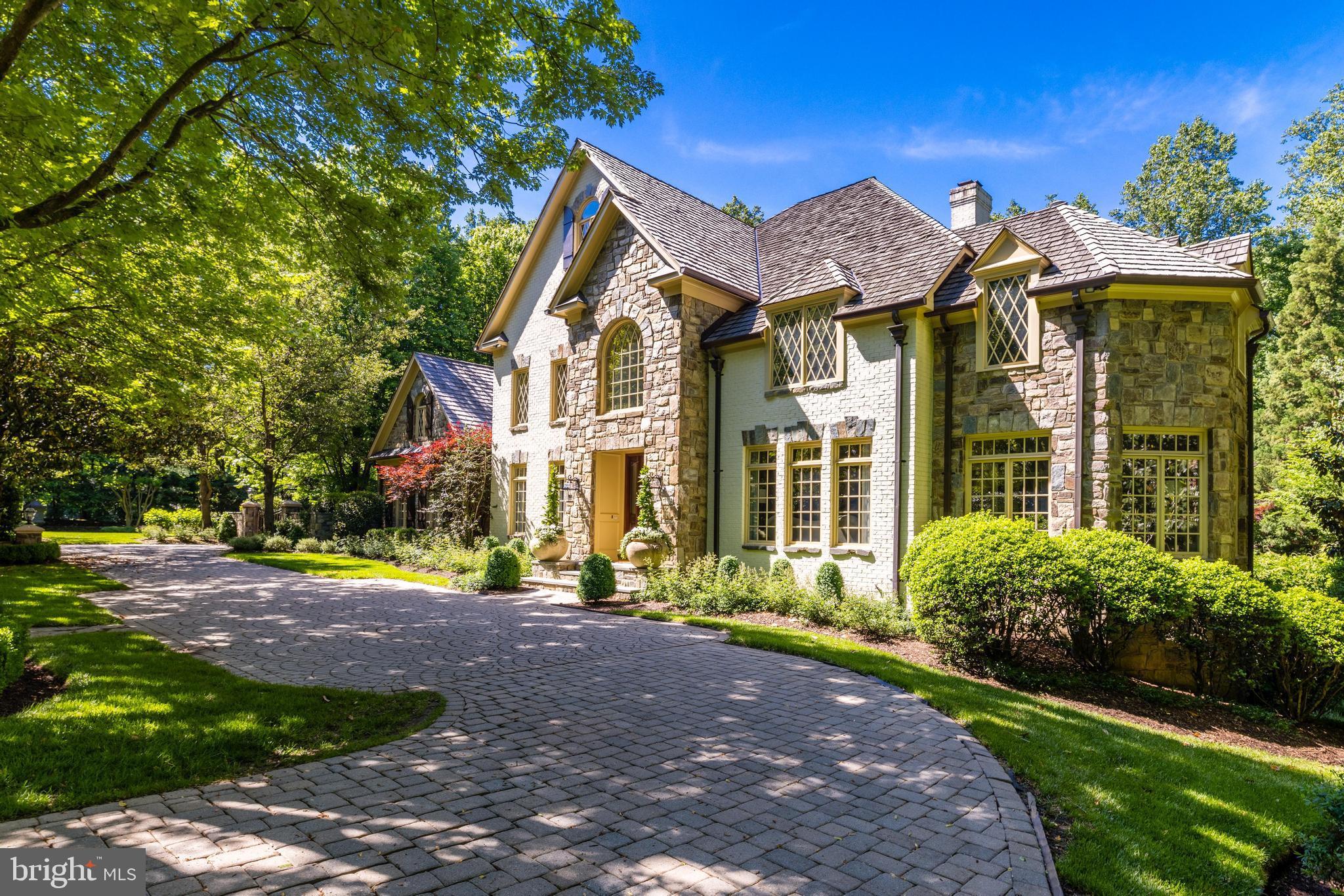 Introducing 10005 Windy Hollow Road, an extraordinary French estate in the exclusive Falcon Ridge neighborhood of Great Falls. Situated on 1.72 private acres, this impressive property offers professionally landscaped grounds, extensive hardscaping, and a dreamy pool/spa combo for the perfect indoor/outdoor lifestyle. The elegant interior features quality craftsmanship and finishes - stone fireplaces, hardwood floors, custom built-ins and extensive molding, trim, and millwork throughout. The floor plan is thoughtfully laid out for elevated living and offers flexible spaces for formal and casual gatherings alike. Work from home in the wood-paneled office, or relax in the sunroom with a double-sided gas fireplace. The gourmet eat-in kitchen features top-of-the-line appliances and a spacious butler's pantry, perfect for hosting dinner parties! The 2-story family room off the kitchen showcases a stunning Palladian window with ample natural sunlight. The main level is rounded out with a formal dining room, sitting room and two half baths. 4 generous bedrooms upstairs all feature en-suite baths and custom closet space. The primary bedroom includes a cozy gas fireplace, cedar closets and a spa-like bath with a soaking tub and separate vanities. The walk-out lower level includes all the amenities your family needs - enjoy a wet-bar with wine storage, a full gym, and home theater. The full 5th bedroom and bath are perfect to host out of town guests or to use as an in-law suite. The charming ivy-covered carriage house offers two additional garage spaces and a full living space upstairs. This studio apartment has been updated with fresh paint and new carpets, and includes a full bath, working kitchenette and built-ins. Incredible outdoor living with a built-in bbq on the deck, multiple trellises and impressive stone features. Enjoy summertime right here in your own backyard with a heated built-in pool and spa. A grassy side yard is perfect for lawn games, playtime and letting pets run free. Take advantage of the private and serene setting whilst enjoying a friendly neighborhood feel that Falcon Ridge has to offer. Located in the desirable Langley High School pyramid and minutes to Tysons Corner, I-495 and the GW Parkway, this is true lifestyle property in the heart of Great Falls. Welcome home!