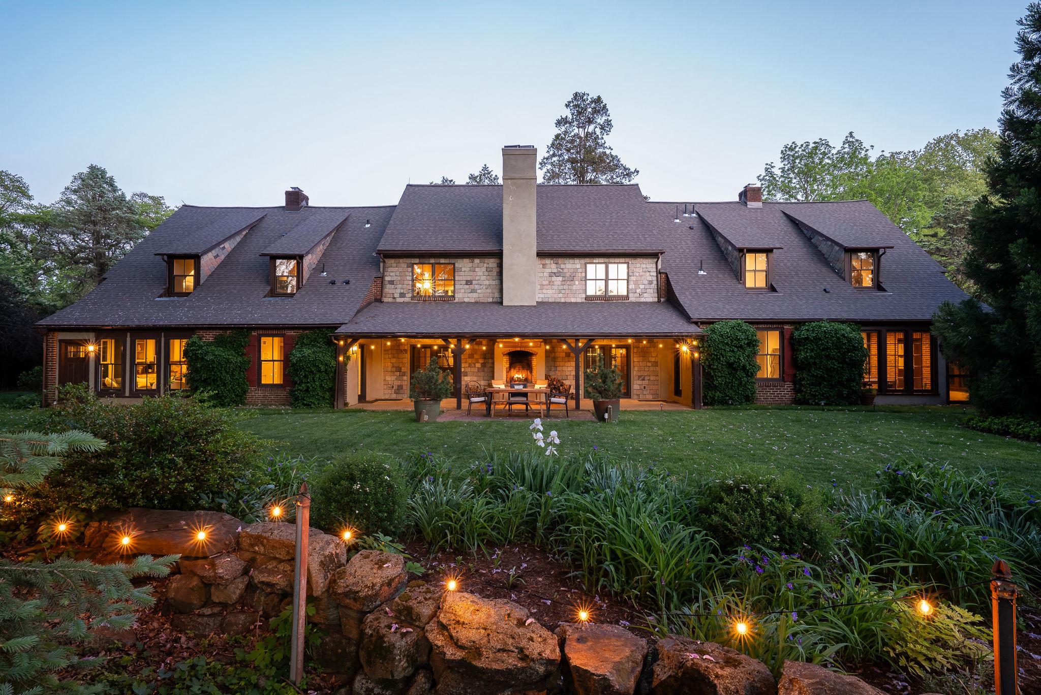 Tucked into the storybook setting of Centreville, this one-of-a-kind home blends timeless European charm with everything today’s buyer is searching for—space, walkability, and peace of mind with major updates already complete. Set beside preserved pastureland, the property offers rare privacy while still being a short stroll from the village’s shops, dining, and playground.

Originally built as two caretaker cottages for a neighboring estate, the home was thoughtfully reimagined into a single, cohesive residence. The result is an architectural gem where old-world craftsmanship meets modern living. Soaring two-story exposed brick walls anchor the dramatic living room, framed by walls of windows that invite natural light from front to back. Exterior slate accents add rich texture and color, enhancing the home’s European feel.

Designed for gathering and entertaining, the home features both indoor and outdoor fireplaces, creating warm, inviting focal points year-round. The layout offers both connection and privacy: the primary suite sits above the kitchen on the east side, while three additional bedrooms occupy the west wing, linked by a balcony overlooking the living space below. A first-floor guest suite with ensuite bath provides ideal accommodations for guests, nanny, or multi-generational living. 2nd Den/family room on first floor or loft area above could be 5th bedroom. 1st and 2nd floor laundry and add'l mudroom add to the convenience.

At the heart of the home, the kitchen is both expansive and cozy, centered around a generous granite island and equipped with dual ovens—perfect for cooking while enjoying views of the surrounding open land and village.

Recent upgrades — including a new roof (2025) and two new HVAC systems (2022/2025) —ensure low-maintenance living. The detached three-car garage adds even more versatility, with nine-foot doors, overhead storage, and an extended patio, complete with hot tub retreat. 

This is more than a home—it’s a lifestyle. A place where charm, comfort, and community come together, and where every gathering feels a little more special. Owner is licensed real estate broker in DE and PA.