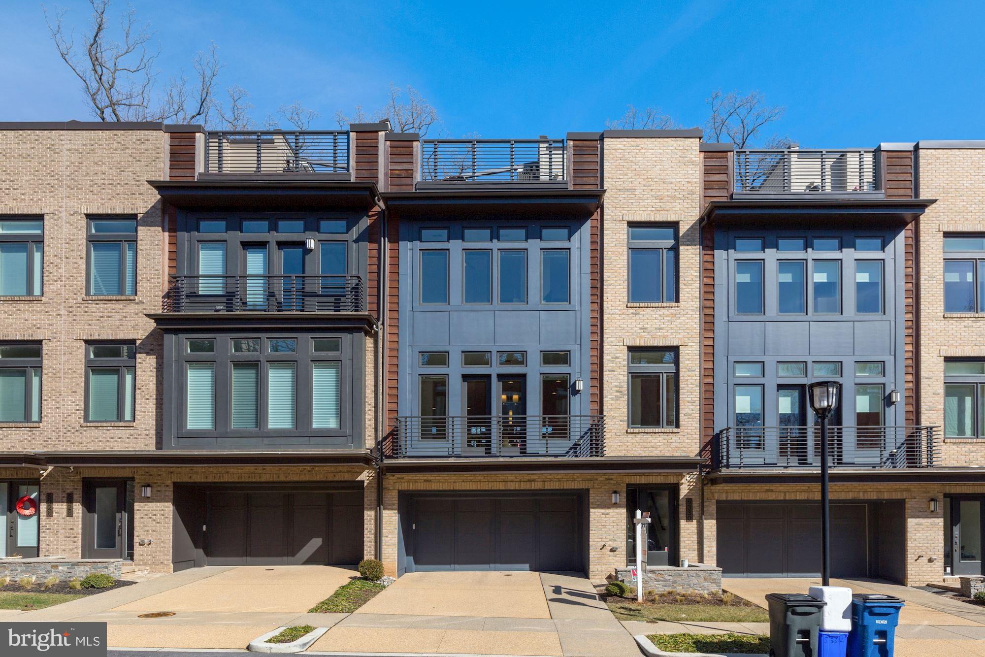Welcome home to this SPECTACULAR, four-level, elevator townhome in the convenient Grosvenor Heights community! Spacious floorplan with soaring 10' main-level ceilings, 9' bedroom-level ceilings, and floor-to-ceiling windows!  Light and bright main entry level, with bedroom/office and full bath off of large two car garage. Private elevator access to all four levels, including rooftop terrace. STUNNING gourmet kitchen with additional breakfast bar and built-ins; Top of the line appliances, including Bosch dishwasher, Sub-Zero refrigerator, Thermador cooktop with contemporary stainless steel and glass range hood, built-in Thermador convection & microwave ovens, all QUARTZ countertops; family room with 42" modern gas fireplace on main living level with contemporary surround, opening to deck with gas grill hook-up; Large open concept dining area, gives plenty of room for entertaining; Guest half bath; Recessed lighting & beautiful hardwood floors throughout. Upper bedroom level boasts large primary bedroom with large walk-in closet, as well as a comfortable en-suite bathroom, including: Frameless glass walk-in shower with curbless entry, polished chrome Kohler fixtures and contemporary shower head, 12"x24" floor and wall tile installed vertically to the ceiling, comfort height WaterSense-labeled water closet with elongated bowl, custom framed mirrors over dual vanity, undermount cast iron sink in granite top; widespread Kohler faucet, and sleek frameless designer cabinetry.  Two additional bedrooms and hall bath with 13" X 13" upgraded floor and wall tiles, as well as a large laundry room with Energy Star washer and dryer, complete the upper level.  If that isn't enough, walk outside to the expansive rooftop terrace with stainless steel cabinetry, sink & Viking refrigerator, Dekton countertop, TV & speaker system, upgraded Brazilian hardwood tiles, retractable awning, retractable shade, lighting throughout,  hose bib and  freestanding grill with gas line. Tons of options for memorable home entertaining!  This home was built to LEED for Homes standards set by the U.S. Green Building Council for environmental friendliness and energy efficiency.