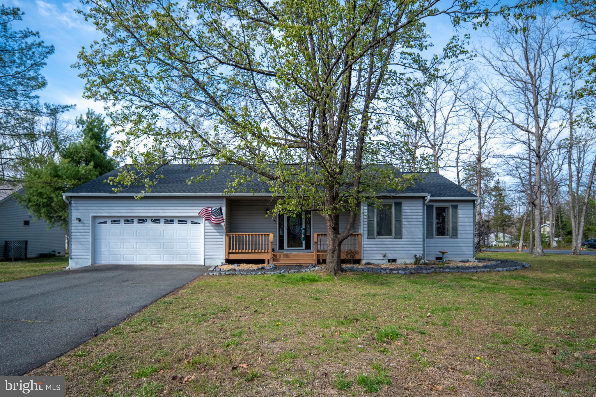 Versatility!!! Beautifully updated one level living in amenity rich Lake of the Woods! A rare opportunity to own this well maintained 3 bed, 3 bath home featuring two primary bedrooms with ensuite baths and an updated kitchen plus a separate kitchenette with it's own entrance, and LVP flooring throughout the house. This home is perfect for multigenerational living, an au-pair suite, or house sharing opportunities. Or use the second generous primary suite in the back for a media room, family room, or flex space- so much versatility! The great room has a cozy, warm vibe with a new fireplace mantle for the gas fireplace that is surrounded by a stone hearth and wall. The main kitchen has new quartz counters, tile backsplash, new floors (2026) and an abundance of cabinet and counter space. The dining room area is generously sized and provides access to the back deck for grilling and outdoor dining. The split bedroom floor plan offers the first primary suite with an updated ensuite bath and a large tiled shower stall on the right side of this home. Along this hall is bedroom and a hall, full bath with a tub shower. On the other side of the home is another spacious primary bedroom with french doors and an ensuite bath with updated tiled shower. This living area also features a second kitchen area currently with a full refrigerator, sink and shelving for a microwave, along with ample space for possible expansion to include a future stove or dishwasher. Between this second primary bedroom and kitchenette is an open office space with a built in desk. Future owners will have peace of mind knowing the roof and gutters were replaced in 2020 and the HVAC was replaced in 2022. Exterior features include a front porch, back deck with two entrances to the home, along with a shed. Completing this home is a two car garage with built in shelving. Lake of the Woods is a beautiful, treed community with both weekend and full time residents, a 550 acre main lake with 13 miles of shoreline and depths reaching up to 45 feet, a second 35 acre fishing lake, marinas, golf course, equine center, tennis/pickleball courts, fitness center, restaurant, club house, and so much more.