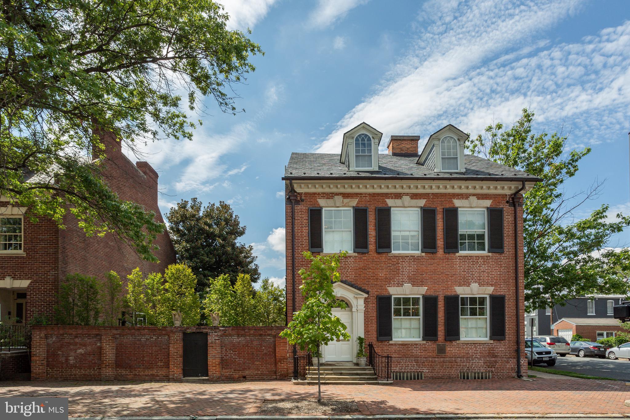 428 N. Washington Street is a grand residence that has been thoughtfully reimagined and renovated for modern living while retaining its historic integrity. The Edmund Jennings Lee house was completed in 1801 and today offers over 7,000 square feet of living space. The gracious main foyer showcases an original etched bell-jar light fixture and hand-plastered tobacco leaf medallion. The expansive formal drawing room boasts 11' ceilings, original heart pine wood floors, in-floor radiant heat and gas fireplace, just 1 of 5 in the home. An elegant dining room spans 22', with a gas fireplace and 2 built-in china cabinets from the Baltimore home of Napoleon's nephew, Jerome Bonaparte.  The back of the house features an exquisitely renovated kitchen with custom Waterworks cabinets and hardware, top of the line appliances including a 43" La Cornue range, built-in Miele coffee maker, Subzero column refrigerator and freezer drawers and 2 Miele dishwashers. The family room, flooded with natural light, adjoins the kitchen and overlooks a private garden oasis.  A heated swimming pool, turf lawn, extensive hardscaping and covered veranda make this the perfect estate for a private respite or entertaining on a grand scale.  Ideally located just 1 mile to Metro and minutes to DC this luxury property is a must see in the heart of Old Town Alexandria.