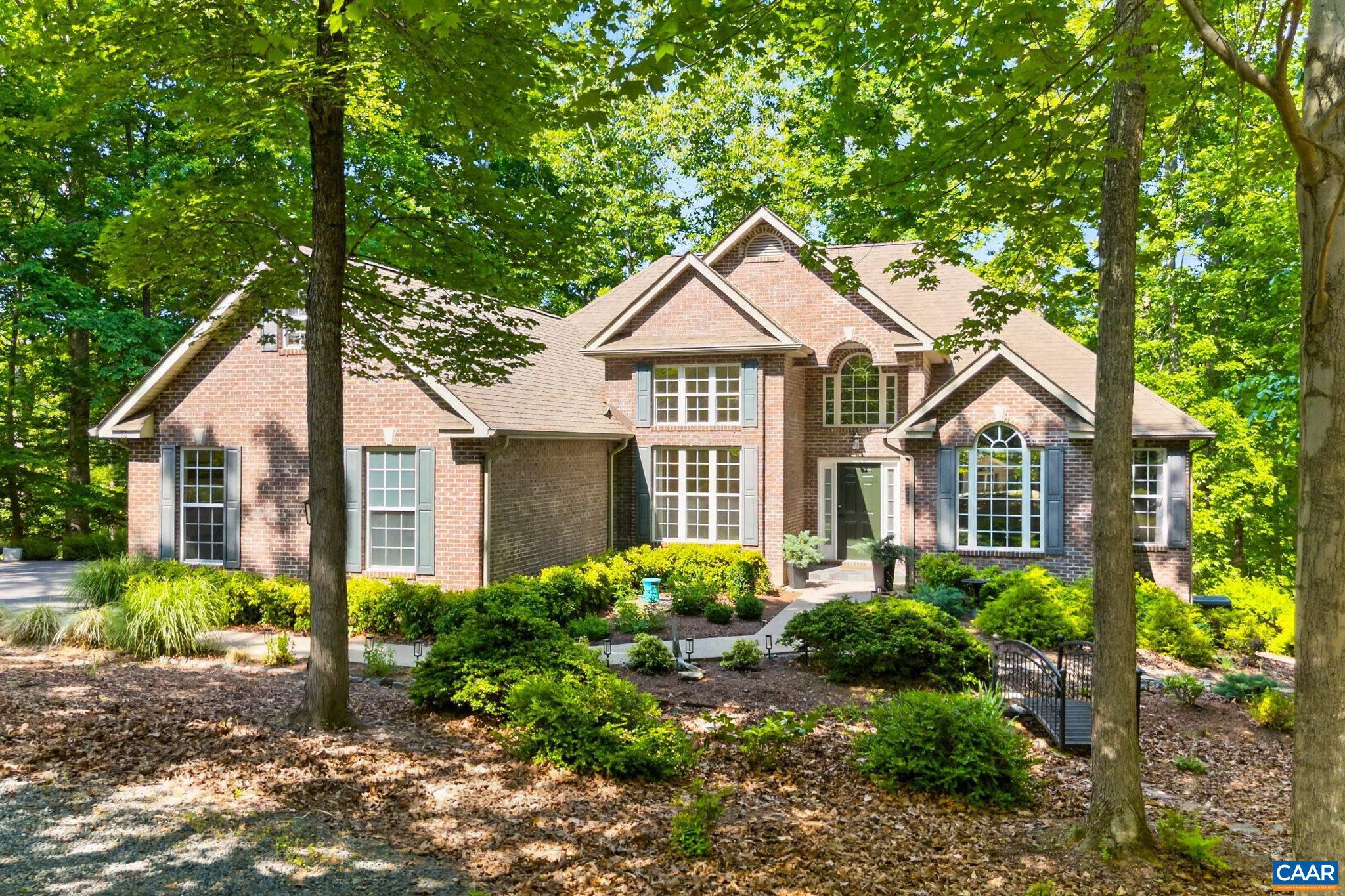 Enjoy the best of Lake Monticello waterfront living in this beautifully updated retreat offering true one-level living. The bright, open floor plan features a spacious living room, dining area, and stunning kitchen with KraftMaid cabinetry, quartz countertops, and designer backsplash. Relax on the screened porch or lakeside deck and take in the water views. Luxury vinyl plank flooring runs throughout the home, while the primary suite offers a tray ceiling, sitting area, and renovated bath with tiled shower and quartz finishes. The walkout basement includes a second kitchen, providing excellent space for guests or multi-generational living. Outside, enjoy 179 feet of waterfront with a deep-water dock, bulkheads on both sides, and built-in benches?perfect for boating, fishing, entertaining, or simply enjoying the lake. A paved driveway, circular gravel drive, beautiful landscaping, and retaining wall complete this exceptional waterfront property.,Quartz Counter,Hickory Cabinets,Fireplace in Living Room