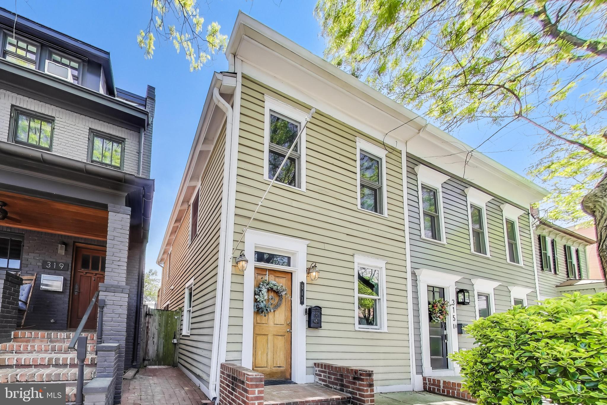 Welcome home to the heart of historic Old Town Alexandria! This quintessential end row townhome is situated just two and a half blocks to vibrant King Street where you can find local favorites like Murphy’s Irish Pub, Misha’s Coffee, and Pop’s Old Fashion Ice Cream, plus both the King Street and Braddock Road Metro Stations are less than a half mile! Inside the freshly painted interior, discover a light-filled living room, high ceilings, modern recessed lighting and sophisticated plantation shutters. Gleaming hand-scraped maple hardwood floors lead you into the elegant dining room, boasting refined crown molding and a built-in bar great for hosting dinner parties. On the back of the home, the expansive kitchen is bright with abundant modern cabinets, stainless steel appliances (all 2023 and still under warranty), and a large pantry. Beautiful original hardwood flooring (1800s) continues up the stairs, where both the tranquil primary bedroom and secondary bedroom are spacious with an abundance of closet space. In the hallway, the handsome full bathroom has been updated with modern elegant finishes. Step outside to revel in your exquisite fenced backyard - one of the larger outdoor spaces in Parker Gray! This irreproducible private brick patio is a private oasis made for outdoor entertaining, gardening, lounging, and dining al fresco. TWO off-street parking spaces convey with the property for your convenience (not that you need a vehicle to live in this desirable spot!). Just minutes to Harris Teeter, Trader Joes, Torpedo Factory, Mt. Vernon Trail, Founders Park, the lively Old Town Alexandria Waterfront, and more! Quick access to Route 1, I-495, I-95, GW Parkway, I-66, and Telegraph Road. Schedule a private tour of your gorgeous new home today and enjoy every moment of the Summer exploring Old Town!