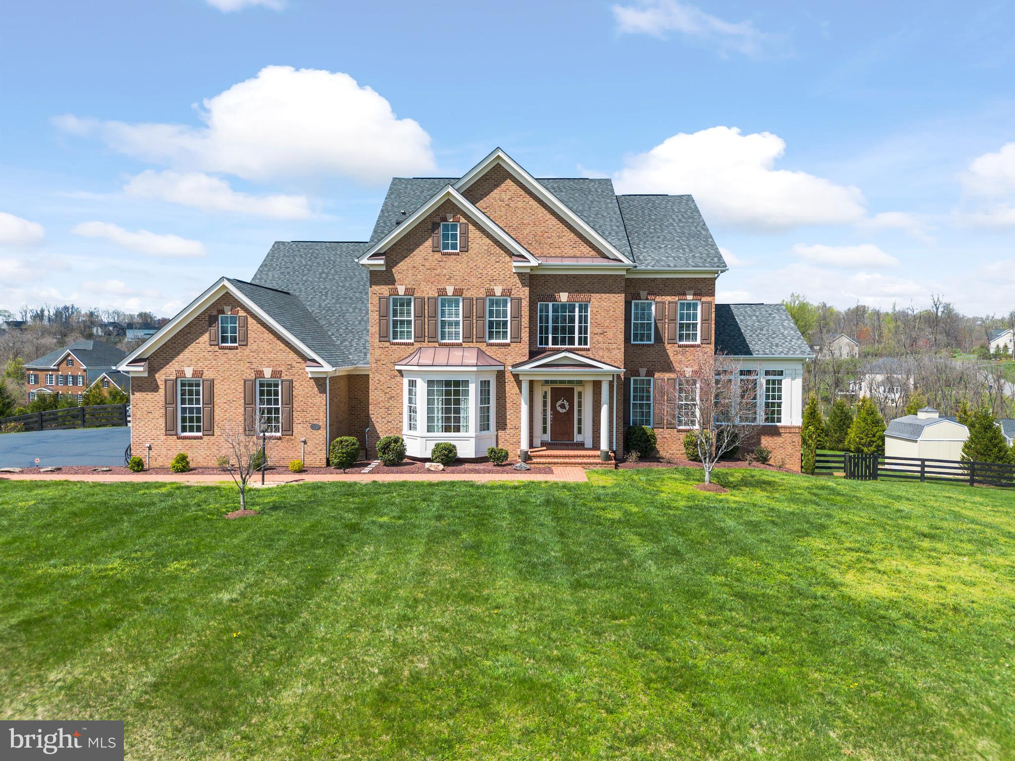 Welcome to this magnificent estate home in Hamilton, blending work, play, and luxury living seamlessly. Set on a sprawling 3-acre fenced property, this stunning residence boasts 5 bedrooms and 4.5 bathrooms across 6,600 sqft of finished living space on three levels, complemented by a three-car side-loading garage.

Step outside to your private entertainment paradise featuring a 22,000-gallon heated diving pool with a sun shelf for lounging. The pool surround includes over 1,000 sq ft of brushed concrete that compliments an additional 600 sqft of stamped concrete patio allowing multiple gathering spots, an 8-person jacuzzi, a cozy fire pit with stone seating wall, and a well-equipped outdoor covered bar area featuring a TV and a pellet grill—perfect for relaxation, rain or shine. Nearby, a stylish pool pavilion bar area offers a prime spot to catch the game alongside a convenient changing area. Golf enthusiasts will delight in the custom tee box positioned approximately 80 yards from the hole. Privacy is paramount with over 70 newly planted trees and expansive storage provided by two large sheds.

The interior is equally impressive with a gourmet kitchen outfitted with granite countertops, stainless steel appliances, and a large walk-in pantry.  An adjacent eating area bathed in natural light leads to the two-tiered composite deck with a custom retractable awning. The two-story family room features a coffered ceiling and a double-sided fireplace that provides the perfect space for relaxation and family gatherings. The main level also includes a dedicated office with built-in bookshelves, an elegant sunroom, a formal living room, and a large dining room with a butler’s pantry.

Upstairs, the master suite is a true retreat, complete with a sitting area, two walk-in closets (one with built-ins), and a luxurious bathroom with dual vanities. Three additional bedrooms—one with an en-suite bath and two sharing a Jack-and-Jill bathroom—offer ample space for family and guests.

The lower level is designed for entertainment, highlighted by a large recreation room, a space ideal for a pool table or gym, and a custom granite wet bar. A unique cedar-lined humidor can also serve as a cigar storage area. Completing this level is a well-appointed bedroom with an oversized walk-in closet and a full bath.

Experience luxury and unparalleled amenities in this exquisite Hamilton estate. Explore this home’s lavish comforts and make it your sanctuary.