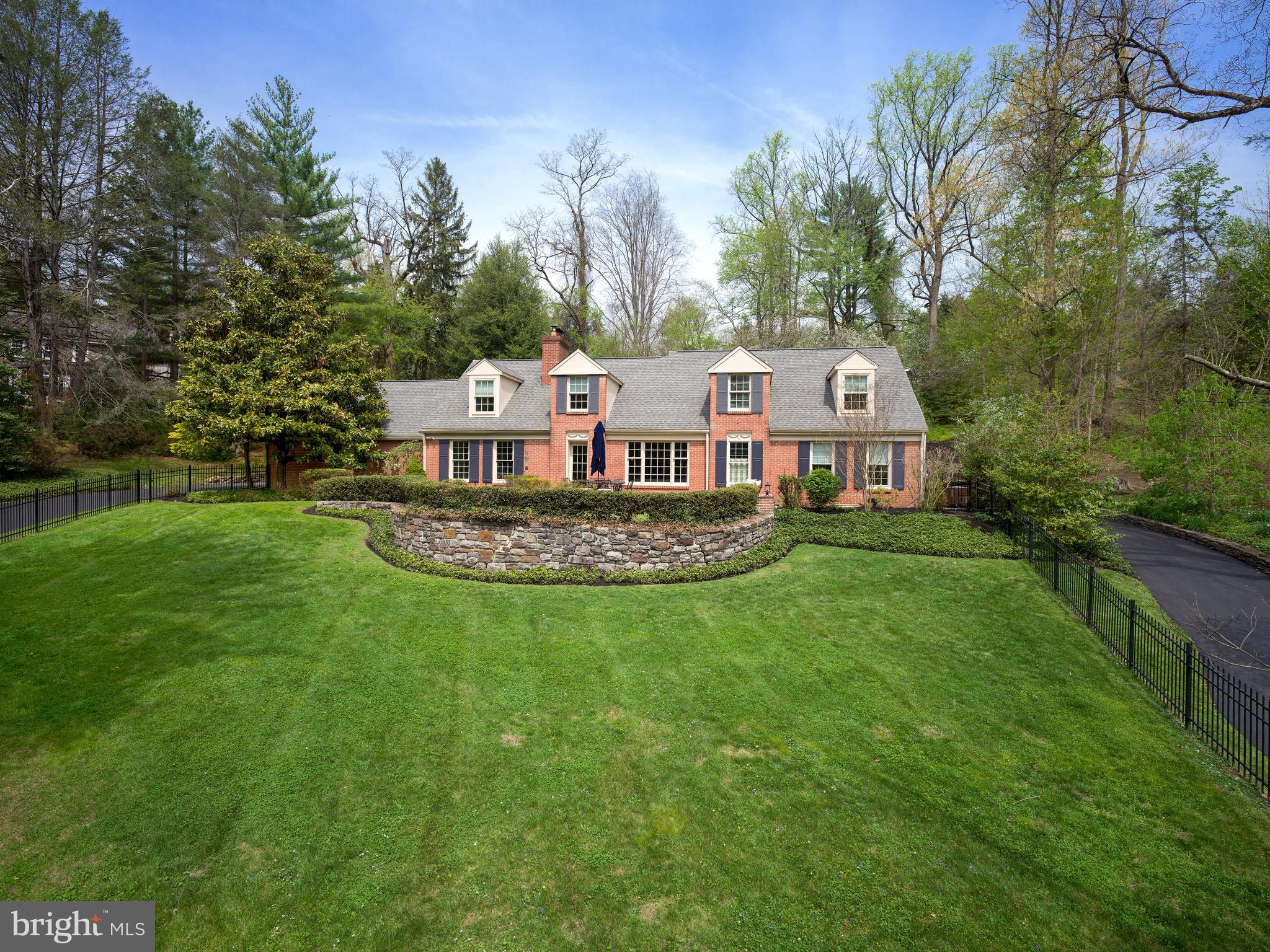A rare Lower Merion lakefront offering with expansive first-floor living, 415 Dove Lake Road pairs unobstructed water views and privacy with a highly functional, family-oriented layout.

Set directly across from Dove Lake in Gladwyne, the home is defined by its setting—open water views, mature trees, and a quiet, tucked-away feel just minutes from Center City. The landscape and light shift throughout the day, creating a setting that is both visually striking and uncommon for the area.

Thoughtfully expanded and rebuilt at the main level, the home offers over 3,300 square feet with a predominantly first-floor layout designed for everyday living and entertaining. The kitchen, dining, and living spaces flow together, centered around a fireside living room that functions as the home’s primary gathering space. The kitchen is well-equipped for both daily use and hosting, with an induction cooktop, double ovens and two dishwashers. 

Glass doors open to a large patio and level, fenced yard, extending the living space outdoors. The setting supports a range of uses—from entertaining to play—while maintaining a sense of privacy. A circular drive wraps the property, providing ample parking and access to the attached garage, with an 18th-century springhouse offering additional storage or garden use.

The bedroom layout is flexible and well-suited to a variety of needs featuring a first floor primary suite, with many options for expansion. A separate upstairs suite accessed by a dedicated staircase provides ideal space for guests, in-laws, or an au pair. Additional bedrooms across the main and upper levels offer versatility for family, office, or guest use.

Recent improvements include a new driveway (2026), updated patio (2019), refreshed landscaping, and mechanical and electrical upgrades that support long-term livability.

The result is a home that combines a rare natural setting with a practical, livable floor plan—offering both retreat-like surroundings and everyday functionality in one of Lower Merion’s most desirable locations.