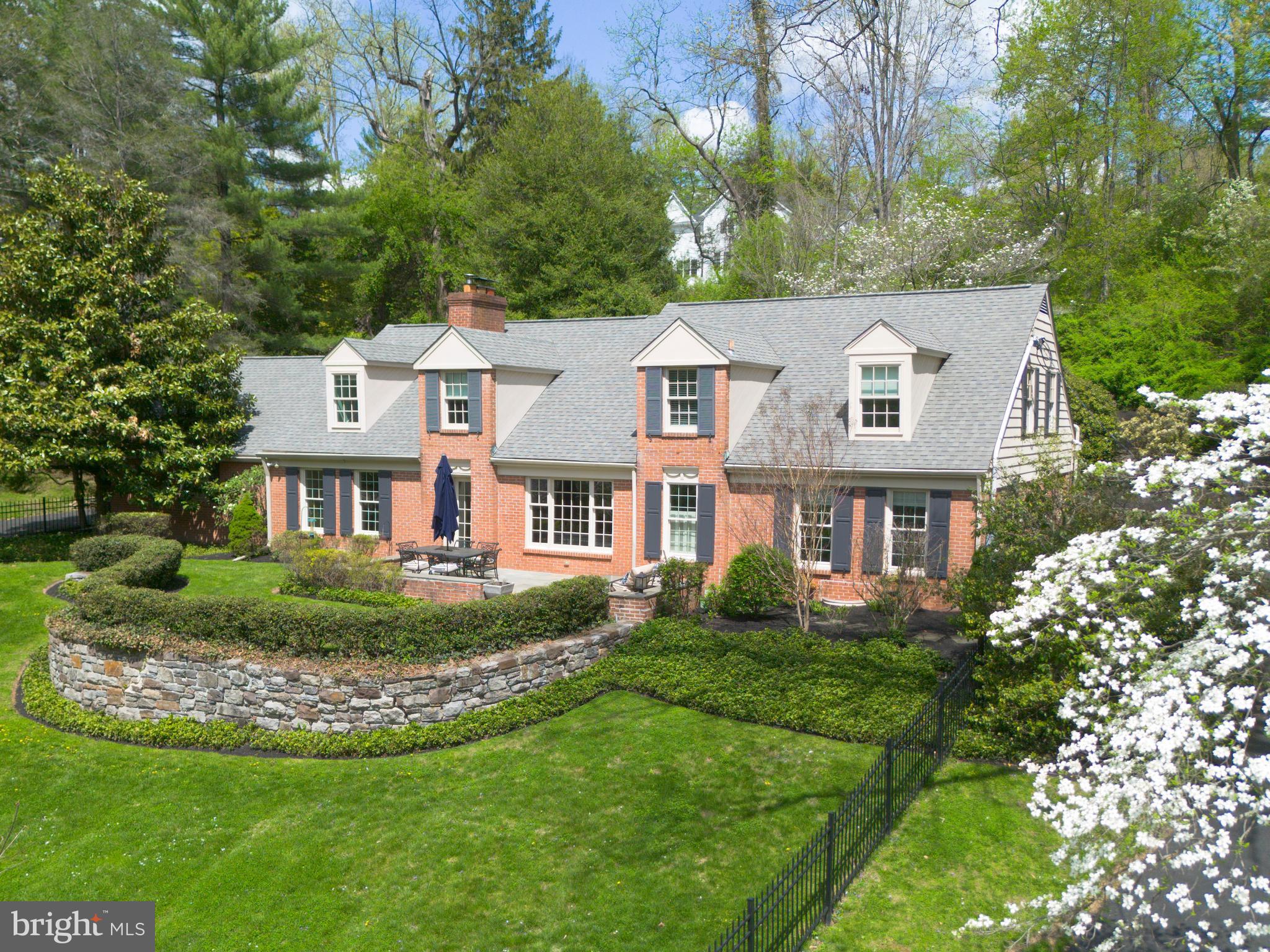 A rare Lower Merion lakefront offering with expansive first-floor living, 415 Dove Lake Road pairs unobstructed water views and privacy with a highly functional, family-oriented layout.

Set directly across from Dove Lake in Gladwyne, the home is defined by its setting—open water views, mature trees, and a quiet, tucked-away feel just minutes from Center City. The landscape and light shift throughout the day, creating a setting that is both visually striking and uncommon for the area.

Thoughtfully expanded and rebuilt at the main level, the home offers over 3,300 square feet with a predominantly first-floor layout designed for everyday living and entertaining. The kitchen, dining, and living spaces flow together, centered around a fireside living room that functions as the home’s primary gathering space. The kitchen is well-equipped for both daily use and hosting, with an induction cooktop, double ovens and two dishwashers. 

Glass doors open to a large patio and level, fenced yard, extending the living space outdoors. The setting supports a range of uses—from entertaining to play—while maintaining a sense of privacy. A circular drive wraps the property, providing ample parking and access to the attached garage, with an 18th-century springhouse offering additional storage or garden use.

The bedroom layout is flexible and well-suited to a variety of needs featuring a first floor primary suite, with many options for expansion. A separate upstairs suite accessed by a dedicated staircase provides ideal space for guests, in-laws, or an au pair. Additional bedrooms across the main and upper levels offer versatility for family, office, or guest use.

Recent improvements include a new driveway (2026), updated patio (2019), refreshed landscaping, and mechanical and electrical upgrades that support long-term livability.

The result is a home that combines a rare natural setting with a practical, livable floor plan—offering both retreat-like surroundings and everyday functionality in one of Lower Merion’s most desirable locations.