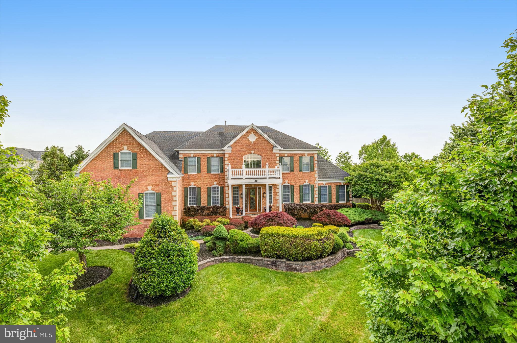 Welcome to this meticulously maintained Toll Brothers Henley model, a residence that redefines luxury living across its three expansive levels. Boasting over 7,900 square feet of finished space, this home presents an unparalleled opportunity to indulge in refined comfort. Situated on a premium, private, fenced one-acre lot, the property is a verdant sanctuary, professionally landscaped with a 17-zone in-ground irrigation system, ensuring effortless beauty. Stepping onto the elegant brick paver walkway, you're greeted by a circular raised planting bed and upgraded exterior lighting, setting a tone of sophistication. Step into a realm of unparalleled luxury and comfort, beginning with a grand two-story foyer that immediately captivates with its sweeping dual staircases and gleaming Brazilian Cherry hardwood floors, which flow seamlessly into the formal Living room, Dining room, Library, and the heart of the home – the Gourmet Kitchen. This isn't just a house; it's an experience. Picture preparing culinary masterpieces in your renovated kitchen, featuring  granite countertops, a spacious island with seating for four, stainless-steel Monogram appliances and the convenience of having dual dishwashers. From here, transition effortlessly into the expansive Great Room with its dramatic stone fireplace, or retreat to the quiet of the Solarium. Move on to the upper level where French doors reveal a Primary Suite that redefines opulence, complete with a sitting room, a spa-like en-suite bath with dual vanities, dual water closets, freestanding soaking tub and enormous walk-in closets. Three spacious bedrooms offering private baths and walk-in closets are sure to spoil family members and guests alike. And the lower level? It's an entertainer's dream, boasting a private bedroom suite with a separate sitting room and en-suite bath , a den/exercise room, plenty of storage; and a home theater and bar area with a full bathroom and gaming area, all leading to a backyard oasis with an inground pool and meticulously landscaped grounds. This home isn't just a place to live; it's a sanctuary designed for the discerning individual who value quality, comfort, and a touch of extravagance. The expansive rear screened porch, complete with dual ceiling fans, and stairs to the patio & rear yard, invites relaxation and entertainment. The luxurious built-in pool, crowned with a pergola, creates a resort-like atmosphere in your own backyard. Located just minutes from Ashburn, One Loudoun, and Cascades shops and restaurants, with effortless access to major commuting routes and Dulles International Airport, this home offers both tranquility and unparalleled convenience. Don't miss this opportunity; make this dream home yours.