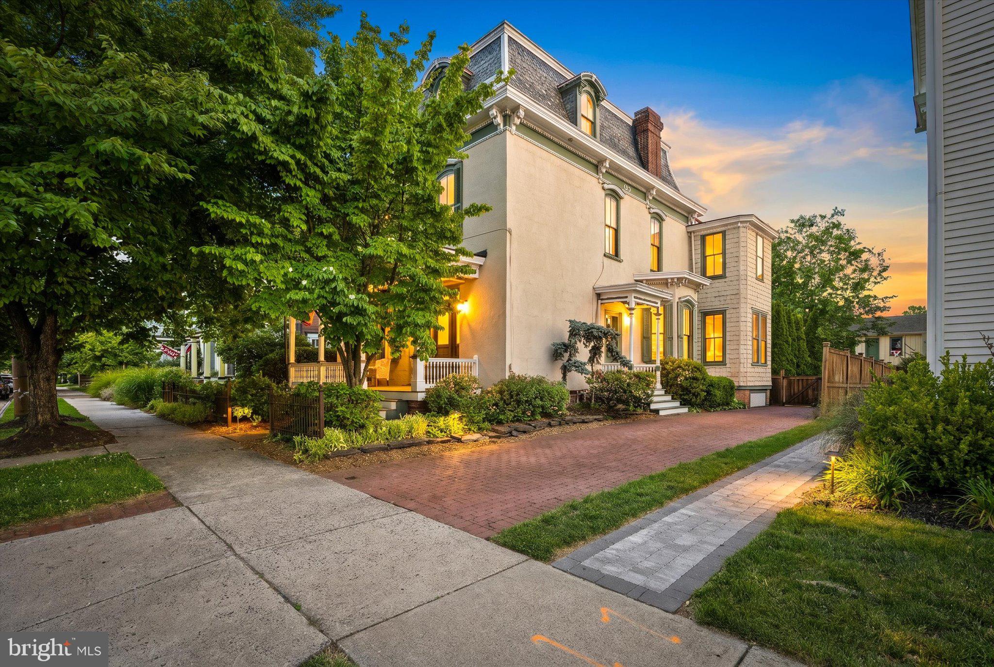 Step into a piece of Bucks County history with this stunning Second Empire Victorian, showcasing a classic mansard roof and three full levels of living space in the heart of Newtown Borough and only blocks from the town center. Known as the Charles Willard House and dating to 1868, this 5 bedroom, 3.5 bath residence pairs period details with thoughtful modern updates in a prime location.

From the moment you arrive, the brick driveway and stately exterior hint at the craftsmanship waiting inside. High ceilings, rich wood floors, period moldings, and a freshly painted neutral palette create a warm and inviting backdrop for everyday living and elegant entertaining. The front entry foyer opens to a living room and adjoining parlor. These flexible spaces are equally suited to be used as a music room, library, media or game room. The parlor has a gas fireplace with Mercer tile surround (current owners have never used) and an exterior door that opens to a quaint side porch. The spacious dining room connects these rooms with the kitchen and family room.

The kitchen is the center of the home, featuring stainless steel appliances, granite counters, a center island for casual dining, and a five burner gas range. The open layout flows seamlessly into the welcoming family room with vaulted ceiling, built-in bookcases, a Vermont Castings wood stove with Mercer tile surround and an exterior door that opens to the rear yard. Rounding out the main level are a half bath, enclosed porch and a butler’s pantry that provides additional storage space.

The second floor features a spacious primary suite with rear yard views, a walk-in closet and an en suite bath, offering a peaceful retreat at the end of the day. Two additional bedrooms, a second full bath with a bath tub, and a laundry room complete this level. The finished third level offers two more bedrooms, a third full bath, a walk-in closet and a versatile bonus room that offers possibilities to be used as an office, playroom or creative workspace.

The home’s outdoor living space has been thoughtfully designed. The fully fenced backyard includes both brick and bluestone patios, creating beautiful spaces for dining and relaxing. The detached carriage house adds tremendous value with space for a workshop, vehicles and additional storage. The partially finished second level can be used for storage or reimagined into a studio, fitness room or gathering space.

Perhaps the home's greatest luxury is its location. Situated in Newtown's historic district and just a short stroll from the heart of Newtown Borough, you'll enjoy easy access to restaurants, charming coffee shops, local boutiques, community events, and the picturesque streets that make this Bucks County town one of the region's most sought after destinations. 204 E. Washington Avenue is more than a home, it's an opportunity to own a piece of Newtown history.