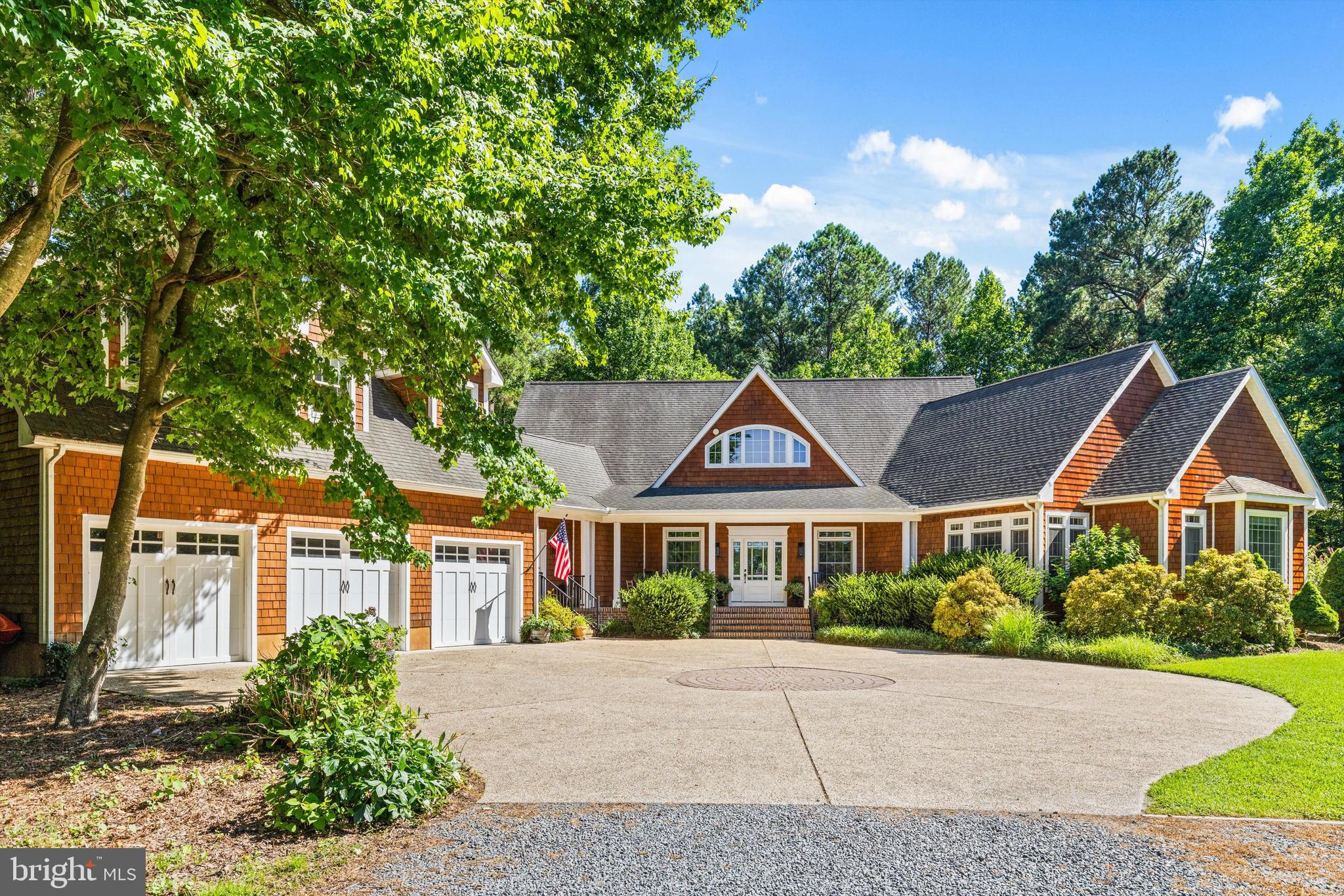 A rare opportunity to own a distinctive custom residence offering approximately 4,200 sq ft of beautifully designed living space on 3.5 private acres in Ocean View. Thoughtfully designed & exceptionally well built, the home combines privacy, gracious one-level living, and remarkable flexibility. CR-1 zoning and an existing shared DelDOT entrance offer possibilities for residential use, business use, or a combination of both. Despite its private setting, the property is a short walk from Good Earth Market & Restaurant for coffee, lunch, dinner, and groceries, as well as Dickens Parlour Theatre. A long gravel drive winds through the wooded setting before opening to a beautifully designed circular parking area accented by a stone paver inlay. Brick steps lead to a welcoming covered front porch with a classic brick floor & custom beveled-glass front door. Designed primarily for one-level living, the home is warm, open, & filled with natural light. Generously proportioned living & dining spaces feature a gas fireplace, custom built-in cabinetry & bookcases, and a built-in bar with glass-front cabinetry. An abundance of windows frames views of the surrounding trees & gardens, bringing the outside in. At the heart of the home is an expansive kitchen designed for serious cooking, relaxed everyday living, and entertaining. Legacy all-wood cabinetry, including extensive glass-front display cabinetry, is paired with honed limestone countertops, high-end appliances, a six-burner gas range, wine refrigerator, second sink, & large center island. Centered within a charming custom tile inlay set into the oak flooring, the island creates a natural gathering place. A custom Dutch door opens directly to the screened porch. Spacious enough for living & dining, the screened porch features a vaulted beadboard ceiling, cedar-shingle walls, and peaceful woodland views. Multiple decks extend the living spaces outdoors, while a professionally designed Japanese-inspired garden adds beauty & tranquility to the private grounds. The expansive primary suite is a private retreat with a sitting room wrapped in rich wood paneling & featuring extensive built-in bookcases, cabinetry, and a Vermont Castings wood stove. The spacious primary bath includes a long double vanity, freestanding soaking tub, oversized glass-enclosed shower, extensive cabinetry, and a wall of windows overlooking the trees. An oversized walk-in closet and private balcony overlooking the gardens complete the suite. Two additional main-level bedrooms share a thoughtfully designed Jack-and-Jill bath. The partial second floor offers a spacious family room, additional bedroom, & full bath. Accessible from both the main residence and its own private entrance, this flexible space is ideal for guests, extended family, a home office, studio, or potential rental use. Built in 2004 with 2x6 exterior walls, exceptional insulation, and cedar perfection-shingle siding, the home features Andersen windows w/ transoms, 3¼" select oak flooring, substantial custom millwork, detailed moldings, five-piece window & door trim, solid-core interior doors, and oil-rubbed bronze hardware. The quality and craftsmanship give the home a sense of substance & permanence that would be difficult to reproduce today. This home's distinctive design was featured in 2004 Delaware Beach Life and showcased on the Beach & Bay Cottage Tour. Additional features include a 3 car garage with carriage-style doors, central vacuum, gas grill connection, encapsulated crawlspace w/ dehumidifier, 3 new HVAC systems, a 2025 Rinnai tankless water heater, private shared well, and oversized septic system. With 3.5 private acres, there is ample room to envision an incredible pool and outdoor retreat while preserving the beauty of the wooded setting. Casually elegant and beautifully crafted, this home feels both substantial and welcoming. A rare combination of acreage, privacy, quality, flexible living space, and CR-1 zoning.