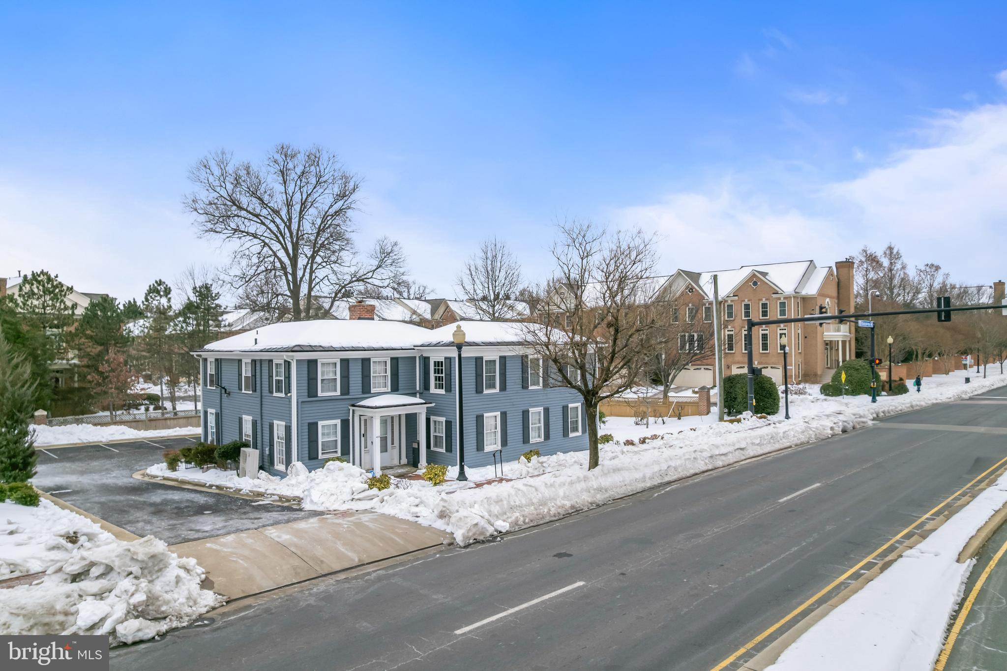 Located at the heart of Old Town Fairfax, 4235 Chain Bridge Road is a distinguished circa-1900 two-story colonial-style office building offering approximately 5,170 square feet of total finished space on a 0.36-acre lot. Originally a private residence, the property has been thoughtfully adapted into a fully operational professional headquarters — most recently serving as the command center for a mid-sized IT firm — while retaining the warmth, character, and intimacy that make it truly one of a kind in the Fairfax City market.
The building presents across three functional levels. The main floor features a large open conference room anchored by an original brick fireplace and ceiling-mounted projector, a formal dining area repurposed as a team gathering space, a full kitchen with island and rear exterior access, a reception area, lounge, private office, and two half baths. The second floor is configured as a multi-office suite with six private offices of varying sizes, a full bath, two half baths, and a generous primary suite with walk-in closet — offering an exceptional live-work or executive residency option. The finished basement rounds out the property with a large open workspace, a dedicated server room, a technical room, and access to a rear patio. Throughout, refinished hardwood floors, abundant natural light from oversized double-hung windows, and independently zoned mini-split HVAC systems create a polished, comfortable working environment. On-site parking is available at the rear of the property.
This property is ideally suited for the professional user or investor who values location, character, and functional versatility over commodity office space. The intimate, multi-room layout combined with meaningful built-in infrastructure makes it a natural fit across a wide range of users — professional services firms seeking a prestigious Old Town address with private partner-level offices; government contractors and IT firms who will recognize the value of an existing server room and proven technical infrastructure; nonprofits and associations drawn to the civic character and proximity to Fairfax City Hall and the Courthouse; and creative agencies or boutique practices looking for an inspired setting that simply cannot be replicated in new construction.