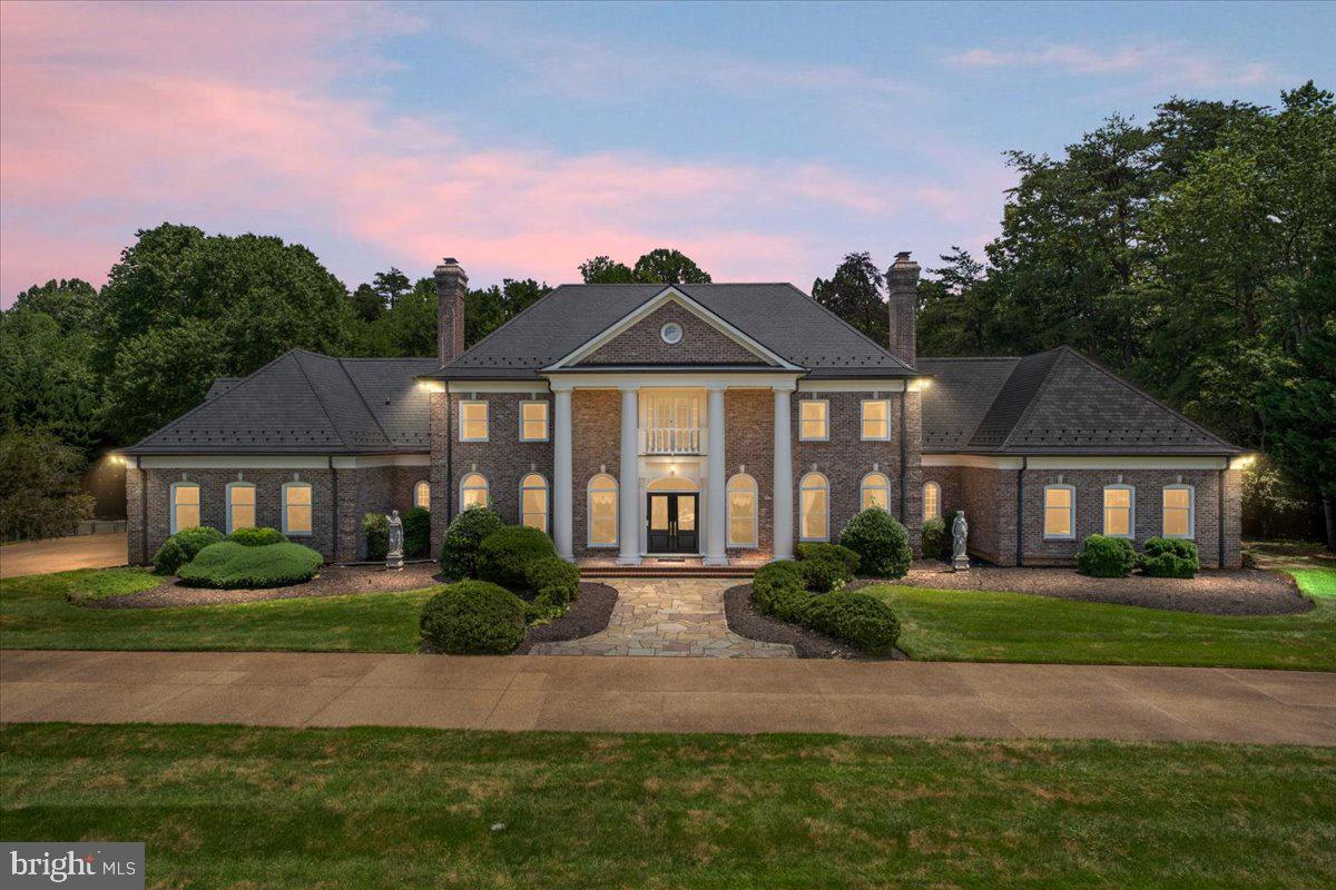 The Jewel of Oakton
Sited on 2 private acres and surrounded by parkland, this majestic double-winged Georgian Colonial will not disappoint. The residence comprises over 14,000 square feet with six bedrooms and seven and a half baths, including a main level ADA-compliant suite. An elevator to all three levels makes aging in place possible. We invite you to visit and experience timeless elegance embodied in all features of the home, including a two-story rotunda with dual curved staircases, a built-in library featuring custom-painted millwork, mahogany bar, cinema room, three-story dry-set fireplace and coffered skylights adorning the Great Room, high-end appliances and custom cabinetry in the freshly painted kitchen, and heated indoor pool pavilion with vaulted teak ceiling and walls. Outside, enjoy the manicured lawn, three-car garage, private tennis court, and expansive deck and terraced areas, ideal for entertaining or quiet relaxation. From its grand architectural presence to its thoughtfully designed amenities, every detail of 2401 Oakmont Court invites you to live remarkably.