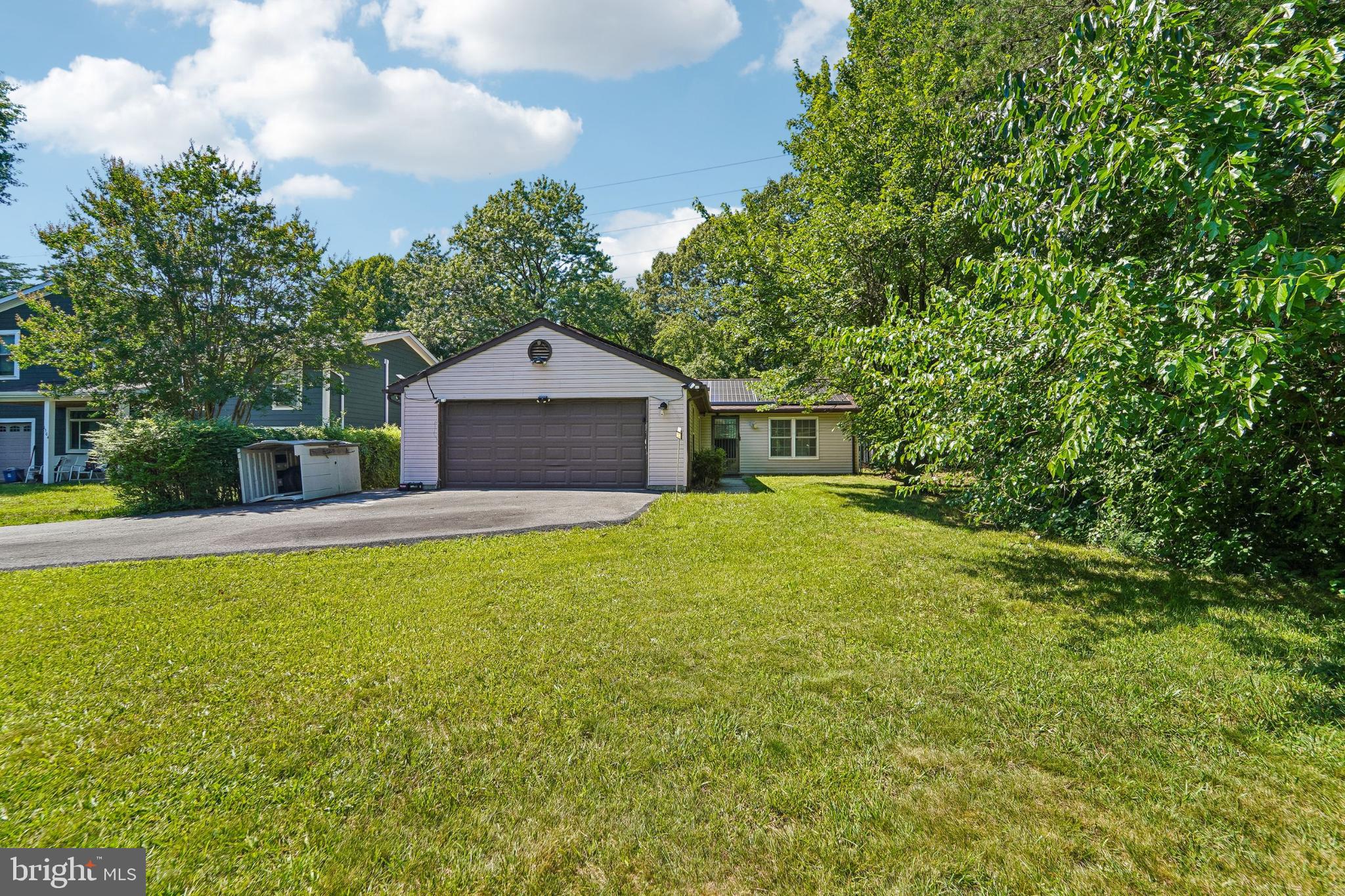 1502 Clearfield Cir is a one-story Severn home built in 1986 with a functional layout and comfortable living spaces throughout. The kitchen features white cabinetry and stainless steel appliances including a refrigerator, range, and microwave, creating a clean and well-equipped cooking space. The living and dining areas feature hardwood floors, adding warmth and continuity to the main living spaces. The bathroom includes a tub and shower combination for everyday convenience. A large tree-lined yard extends the living space outdoors, creating ample room for relaxation and entertaining. A detached two-car garage completes this well-maintained residence with practical amenities throughout every room.