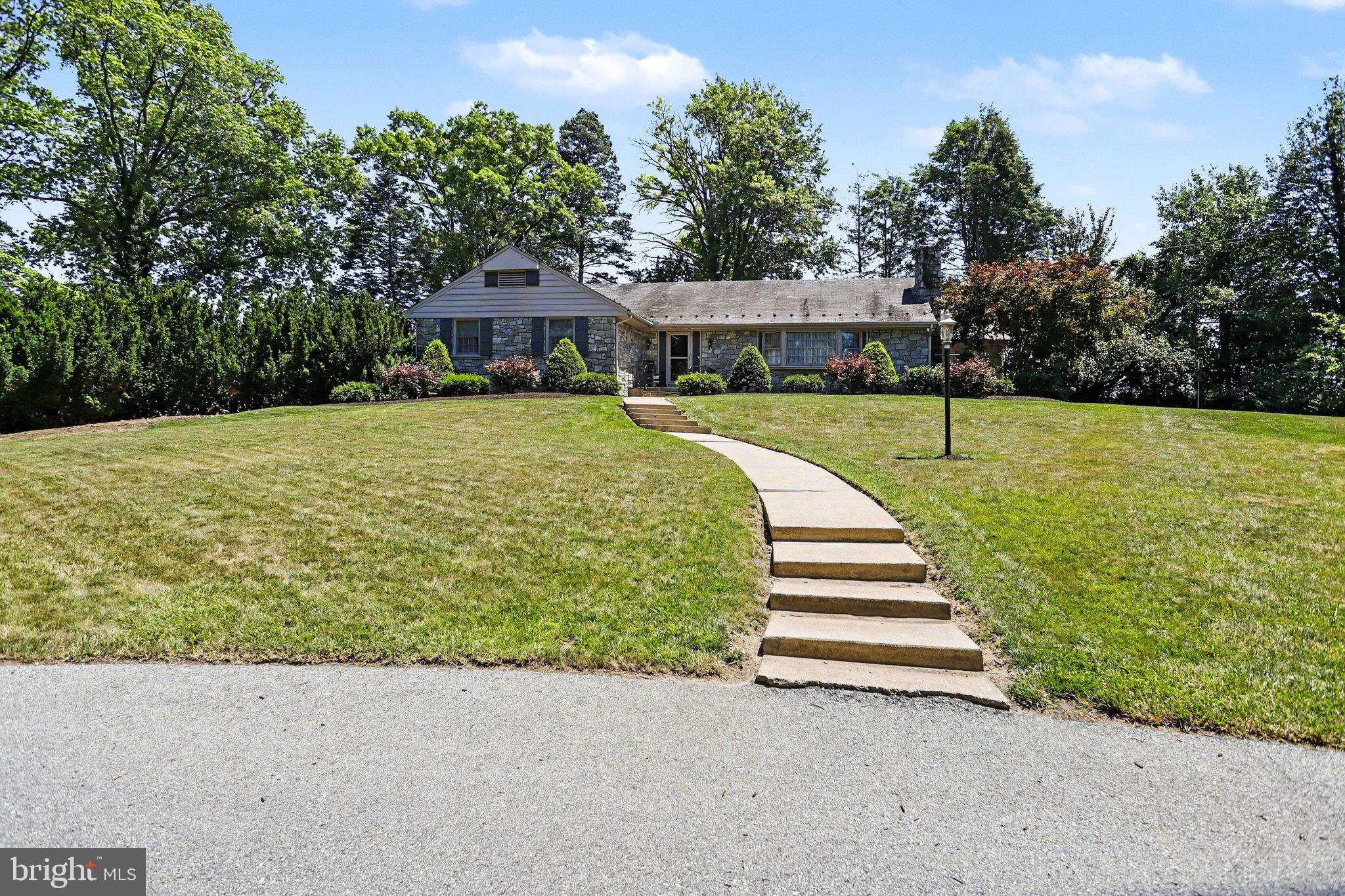 Absolutely stunning and meticulously maintained home situated on an incredible .83-acre lot! Lovingly cared for by the same owner for nearly 30 years, this exceptional property showcases pride of ownership throughout. From the moment you arrive, you'll be impressed by the outstanding curb appeal featuring a beautifully landscaped yard, mature trees, extensive hardscaping, a large paved driveway, side-entry oversized 2-car garage with workshop area, real stone exterior, and a timeless slate roof. A walkway leads to the inviting flagstone front porch and into the welcoming foyer featuring crown molding, coat closet, and luxury vinyl tile flooring. The spacious living room is filled with character and warmth, offering a beautiful wood-burning brick fireplace with custom built-in surround, large bay window, and coffered ceiling. The remodeled kitchen is both beautiful and functional. It features painted cabinetry with a stylish gray glaze finish, granite countertops, custom tile backsplash, range hood, center island with seating, coffee bar area, and additional bar seating that opens to the dining room. An exterior door offers convenient access to the patio and backyard. The dining room is generously sized and features wood flooring, crown molding, chair rail, ceiling fan, and a large bay window overlooking the picturesque backyard. Enjoy peaceful views while dining or entertaining. Just off the dining area is a charming sunroom with ceiling fan and sliding glass door leading to an additional patio area, creating the perfect place to enjoy morning coffee, read a book, or take in the beauty of the surrounding landscape. The bedroom wing offers excellent storage with multiple hallway closets. The spacious primary bedroom features crown molding, ceiling fan, two double closets, and a private full bath with tub/shower combination, linen closet, and newer luxury vinyl tile flooring. Bedroom two is generously sized and includes a ceiling fan and double closet. Bedroom three offers crown molding, chair rail molding, and a double closet. The remodeled main bathroom is beautifully updated with tile flooring, double vanity, tiled shower walls, and a built-in niche for added beauty and convenience. The lower level offers an impressive amount of additional living space and flexibility. The huge family room features a second wood-burning fireplace, built-in shelving, daylight windows, and plenty of room for recreation, entertaining, or movie nights. A large versatile room with custom built-ins, walk-in closet, and its own exterior entrance provides endless possibilities as a home office, guest room, hobby room, exercise room, or creative workspace. Also located on the lower level is a remodeled half bath, a spacious laundry room with utility sink and built-in storage, and a utility/storage room. You must see the wonderful oversized 2-car garage which offers abundant space not only for vehicles but also for a workshop, storage, tools, and equipment. The true highlight of this property is the remarkable outdoor setting. Situated on a sprawling .83-acre lot, the grounds have been thoughtfully designed and lovingly maintained. Mature trees provide privacy and shade, while extensive hardscaping creates visual interest and functionality. Enjoy the peaceful pond, beautiful stonework, raised garden beds, patios, and numerous areas to relax and enjoy nature. The backyard offers a uniquely private setting that is difficult to find, creating a tranquil retreat that feels far removed from the hustle and bustle of everyday life. Homes offering this level of care, character, space, and outdoor beauty rarely become available. If you've been searching for a property that combines quality construction, thoughtful updates, generous living space, and an extraordinary lot, this may be the one you've been waiting for! This is a rare opportunity to own a truly special home on one of the area's most beautiful lots!