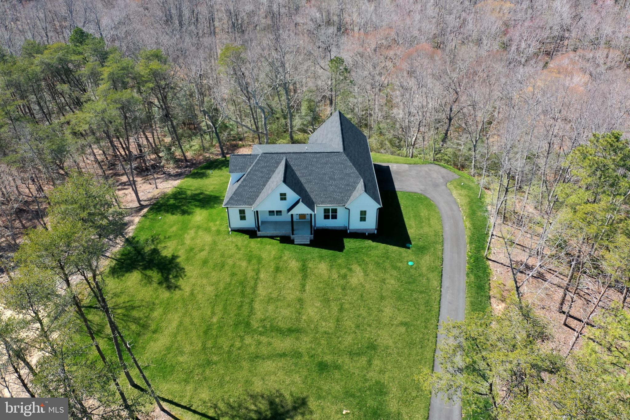**Exquisite Luxury Living on a Private Wooded Lot** Welcome to this stunning new build, offering an unmatched blend of elegance, modern amenities, and serene privacy. Spanning over 3,400 square feet above grade plus a finished basement! This 5-bedroom, 4.5-bath home is designed for those who appreciate fine craftsmanship and sophisticated style. From the chef’s gourmet kitchen, complete with quartz countertops and top-of-the-line appliances, to the luxurious wood floors throughout the main and upper levels, no detail has been overlooked. Relax and entertain in one of three spacious family rooms, or retreat to the beautifully appointed bedrooms with custom tile baths for a spa-like experience. The oversized 2-bay side-load garage can easily accommodate your luxury vehicles, while the additional 1-bay garage offers added convenience. Set on a large, wooded lot with no HOA, you’ll enjoy both the beauty of nature and the privacy it provides. This is truly a one-of-a-kind home, offering a lifestyle of refined comfort and modern luxury. Schedule your private tour today to experience it for yourself and be sure to view the virtual tour to experience the layout.