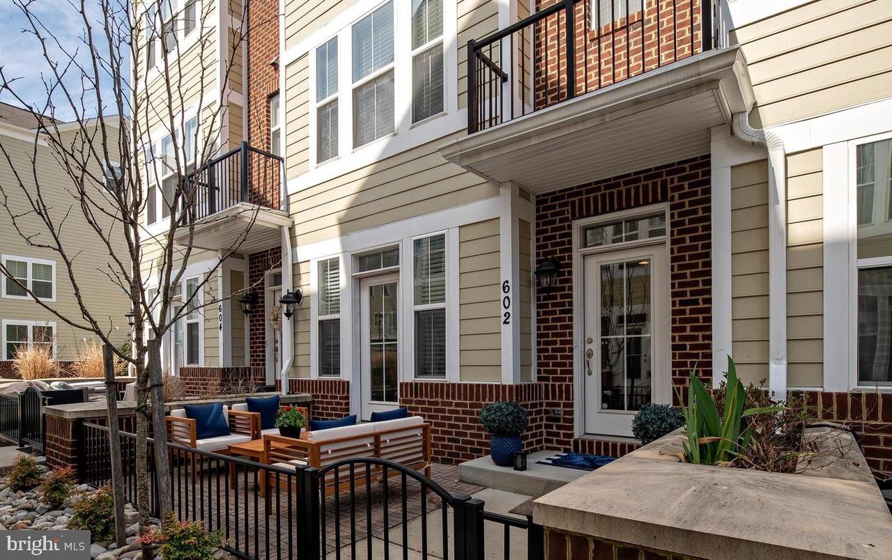 Location! Location! Location! Nestled in the vibrant heart of Annapolis Towne Center, this beautifully maintained, move-in-ready townhome offers the perfect blend of modern luxury and urban convenience.  
Versatile Ground Level: Features a flexible bonus space perfect for a home office, yoga studio, or media room, leading to a rear brick patio and a rare two-car garage.
Gourmet Dream Kitchen: A showstopping open-concept center island, pristine white cabinetry, top-tier granite, stainless steel appliances, and a frosted-glass pantry seamlessly connects the living and dining areas.  Unwind by the cozy gas fireplace, framed by custom built-in bookcases, or step out onto the private deck for morning coffee or evening grilling.
Luxurious Primary Suite: The upper-level retreat boasts a dual-sink vanity, a large-tiled custom shower, and a separate water closet. A second spacious bedroom features its own private en-suite bath.
Spectacular 4th-Level Loft: An incredible entertaining space complete with a third bedroom suite, full bath, and a private rooftop deck—ideal for hosting unforgettable guest stays or parties.
Live just minutes away from top-rated dining, premier shopping, entertainment, and everything Annapolis has to offer. Welcome home!