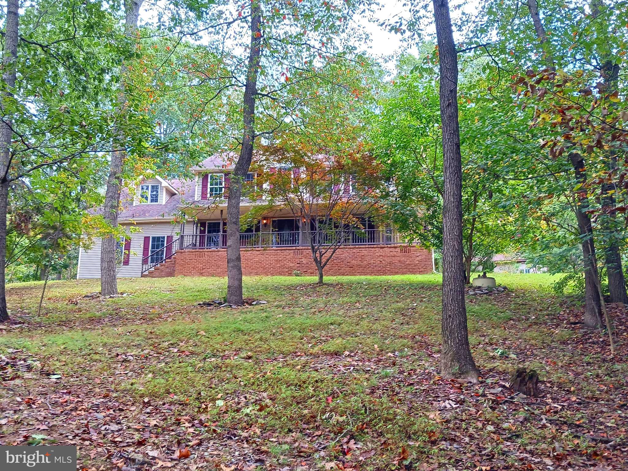 Custom built beautiful, PRIVATE setting with 4 bedrooms, 2 full and 2 half baths home.   Primary bedroom with WIC and primary bath with jacuzzi tub and separate shower. Home has a large covered front and side porch along with a large deck on the back,  full finished basement and 2 large outbuildings that could be a recreational storage and the one below as you enter the property could be for a business subject to zoning.  Also included is a fenced area for pets.  If you cherish your privacy and need space, this is for you.  Two laundry hook up areas, one upper level and one on main floor.  You may remember Forest Park in Hanover, where the  gorgeous hardwood floors in formal dining and living room originated.  Nice kitchen with Great sunroom, all open to family room. Wood beams in basement  along with an additional wood stove hook up. The two stone fireplace walls are actual stones from property.  Tons of storage all through the house and also in the large outbuildings.  Move in ready!