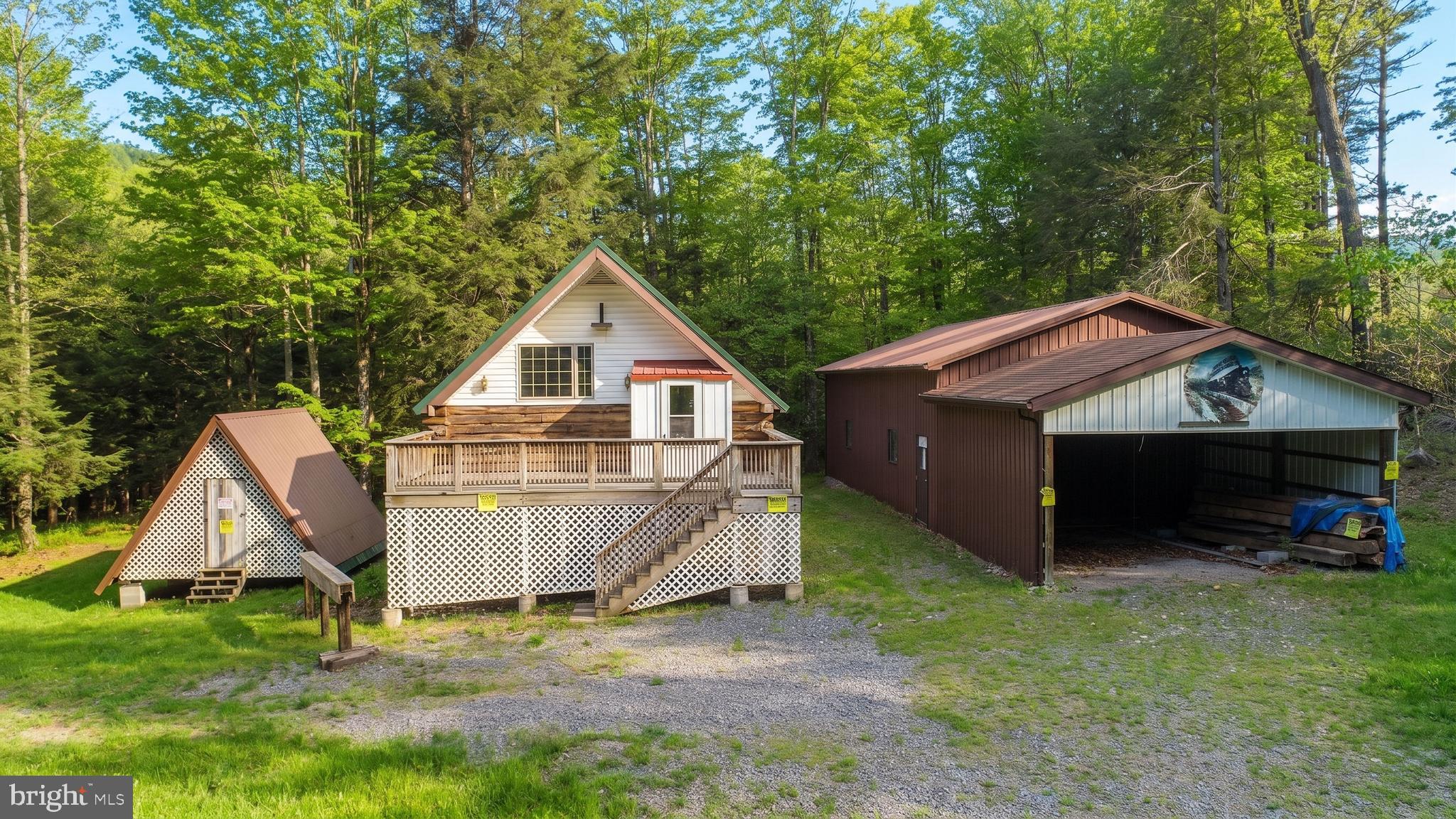 Nestled in the scenic countryside of Southern Garrett County, on 5+ acre property along North Fork Sand Run, this  two-level home provides a solid foundation for renovation or customization, making it ideal for a full-time residence or  mountain getaway. In addition to the home, the property features a large detached garage perfect for vehicles, equipment, hobbies, or workshop space, along with a separate storage building for added convenience. Public water service is already in place, and county road frontage allows for easy year-round access. With ample acreage for recreation, gardening, or future improvements, this property presents endless possibilities for buyers looking to create their own retreat in the mountains of Western Maryland. Call today for your private showing.