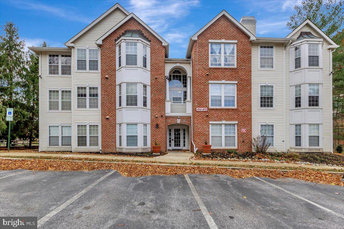 Welcome to this beautiful condo in Owings Mills, a spacious 3-bedroom 2-bath second-floor home offering approximately 1,316 sq. ft., making it one of the largest units in the building. Large windows fill the interior with natural light and the space has been updated with fresh paint, brand-new carpet, and a new HVAC system installed in 2025. The eat-in kitchen features granite countertops and the living room includes a cozy gas fireplace and access to a private balcony that backs to mature trees, creating a peaceful outdoor escape. The primary bedroom is generously sized with its own private bath and a separate laundry room adds everyday convenience. The building’s interior common areas were recently renovated and the community provides ample parking, strong lighting, key-limited entrance doors, and a convenient buzz-in system that rings directly to your cell phone. The monthly condo fee covers water/sewer, trash, snow removal, lawn care, and common area maintenance. This condo is part of the New Town community, which includes multiple pools, a community center, dog run, tennis courts, walking paths, garden beds, and more. The location is truly exceptional with an easy walk to shopping, restaurants, and daycare, plus quick commuter access to 795, making daily travel fast and convenient. This home combines comfort, convenience, and style in a truly move-in-ready setting. Some photos may include virtual staging.