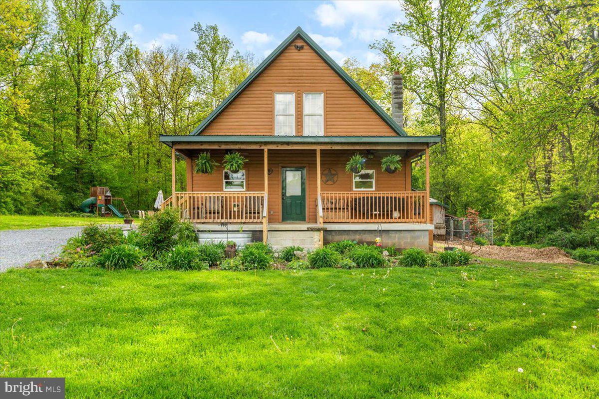 Escape to the mountains in this charming 3-bedroom, 3-bathroom cabin-style home offering panoramic mountain views and timeless rustic character. Nestled in a serene setting, this beautifully crafted home combines natural beauty with modern comfort.

Inside, you’ll find a warm, open concept living space with exposed wood beams, and an open kitchen that’s perfect for entertaining. The kitchen features ample counter space, a breakfast bar, and room for family gatherings or quiet mornings with a view. Retreat to the living room for a movie, game night, or reading.

The spacious first-floor owner's suite provides comfort and privacy, complete with an en-suite bath and large walk-in closet. Upstairs you will find two additional bedrooms and another full bathroom equipped with a custom shower.

Whether you’re enjoying coffee on the covered front porch, hosting friends for a BBQ, or simply relaxing after a long day, this home offers the perfect balance of rustic living and everyday convenience. Located near National Parks, Fort Ritchie, stocked fishing creeks, historic Frederick and Gettysburg, and short, gorgeous drive to the highway.

Your mountain retreat awaits—schedule your private tour today.
