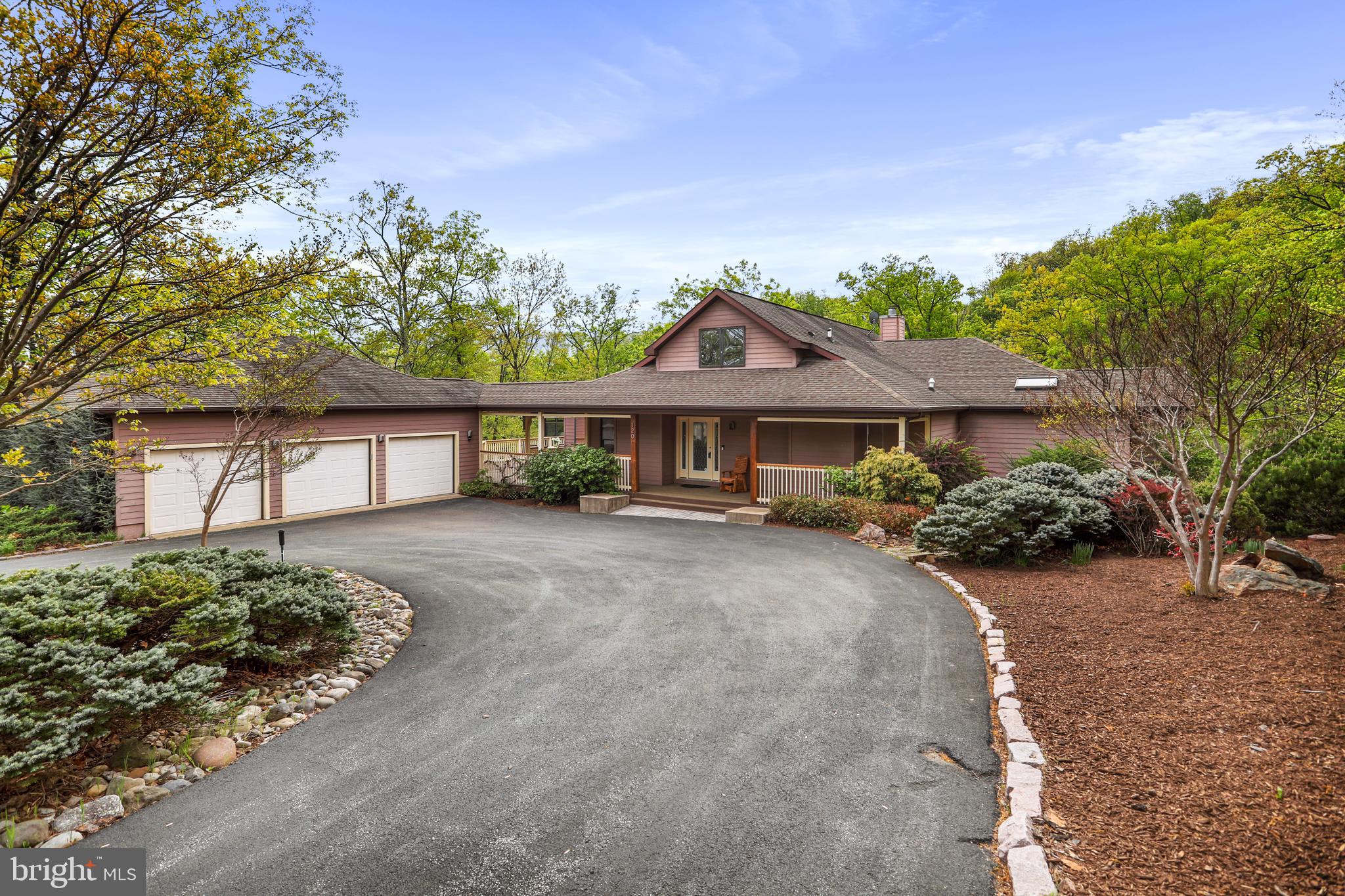 Architectural Drama Meets Resort-Style Living
Tucked high on Lookout Ridge, this extraordinary contemporary home delivers the rare blend of bold design and everyday functionality—all nestled within the sought-after community of The Woods. Built in 2001 and offering over 5,000 square feet of flexible living space, this 4-bedroom, 5-bath home is as much a private retreat as it is an entertainer’s dream, featuring an indoor lap pool, detached three-car garage with workspace, and a full lower-level apartment.

Step inside to a breathtaking main level where cathedral ceilings with exposed beams and a dramatic wall of windows welcome you into a living space bathed in natural light. Hardwood floors flow throughout the main level, complementing the open layout. The chef’s kitchen is a showpiece—quartz countertops, stainless steel commercial-grade appliances, a mobile butcher block island, and a spacious wraparound counter that flows into the fireside family room. Anchored by a floor-to-ceiling stone fireplace and surrounded by treetop views, this space is the heart of the home.

The luxurious main-level primary suite is a true sanctuary, featuring a private indoor lap pool, spa-inspired bath with a walk-in tiled shower, dual water closets, and a cedar-lined walk-in closet. A spacious solarium and an additional entertainment room with a wet bar provide serene, sunlit gathering spaces year-round. An additional main-level bedroom or home office, full bath, and large laundry room complete this level.

Upstairs, a loft bedroom with a private full bath offers comfort and privacy while overlooking the main living space below. All bedrooms are carpeted for added warmth and comfort.

The fully finished walk-out lower level is ideal for multi-generational living or effortless entertaining. It includes a private entrance, full kitchen, spacious living area, a guest full bath, and a generous bedroom suite featuring a private full bath and a massive walk-in closet. A second laundry area with a full-size stacked washer and dryer adds everyday convenience. Just off the living area, a bonus room with built-in shelving and a desk/counter workspace offers the perfect spot for a home office, studio, or hobby room. There’s also a separate utility and storage area housing a brand new 80-gallon hybrid water heater and heat pump. Durable and stylish 2’ x 2’ tile runs throughout this level.

The outdoor space is nothing short of park-like—peaceful, expansive, and thoughtfully designed. Follow the stone path to a large fire pit area surrounded by seating, perfect for gatherings under the stars. A fenced yard provides peace of mind for kids and pets alike, while expansive decks and porches create ideal spaces for entertaining or unwinding.

A circular driveway and oversized three-car garage with workspace complete this exceptional offering. Even better? This home is being sold fully furnished—completely turnkey and move-in ready. Window treatments also convey. Just bring your suitcase and settle in.

A Class A membership to The Woods Club conveys with the property, granting access to top-tier amenities including golf, indoor and outdoor swimming pools, a fitness center, tennis and pickleball courts, scenic hiking trails, and clubhouse dining. Whether you're enjoying morning coffee in the solarium, hosting dinner on the deck, or heading out for a round of golf, this home provides an effortless connection to The Woods’ resort-style lifestyle.

For those seeking a retreat that redefines contemporary living—with space to breathe, room to gather, and luxury at every turn—welcome home to 120 Lookout Ridge.