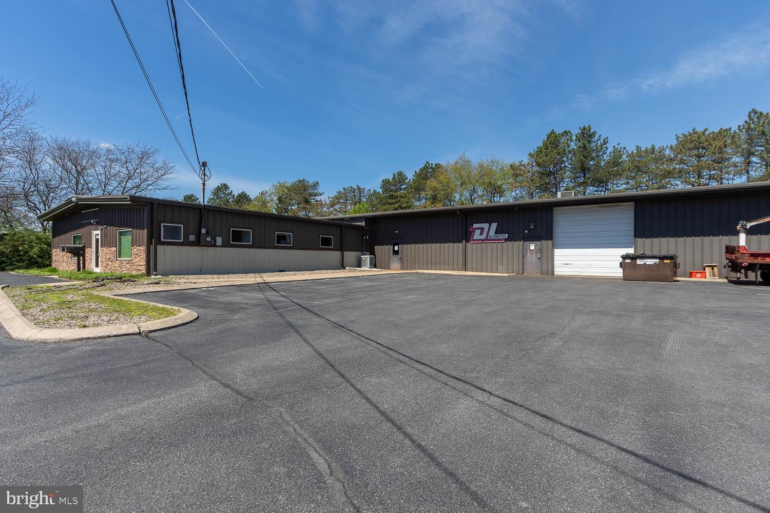 This versatile 10,272-square-foot commercial property in College Township offers a blend of professional office and garage space, located just minutes from downtown State College and Bellefonte. The 1,920-square-foot office suite is designed for productivity, featuring a welcoming waiting area, five private offices, and a large central room perfect for a showroom or collaborative workspace. A convenient kitchenette and separate men's and women's restrooms are also available. The expansive 8,352-square-foot flex space is currently utilized as an auto garage but offers a high-volume area easily adaptable for multiple uses. With 17 parking spaces and flexible General Commercial zoning, this property provides a functional footprint in a strategic location.