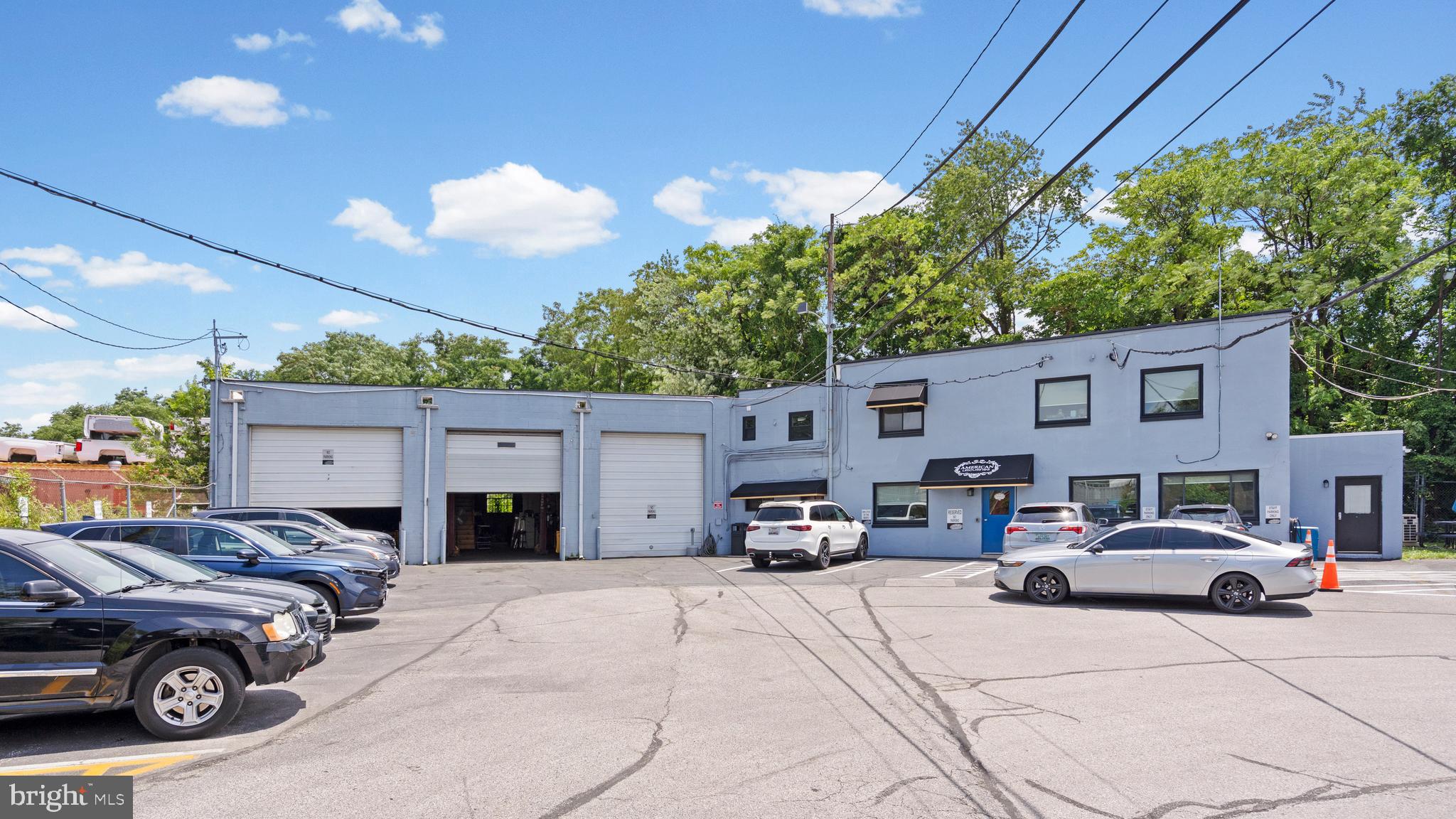 Exceptional opportunity to own a well-maintained commercial property offering a rare combination of office, warehouse, service, and fleet storage space on a generously sized lot. Designed for efficiency and functionality, this versatile property is ideal for a wide variety of owner-users or investors, including transportation, automotive, contractor, logistics, service, or industrial operations. The property features multiple professional office suites with private offices, open workstations, conference areas, employee break rooms, and reception spaces, providing ample room for administrative staff and day-to-day operations. Numerous updated workspaces allow multiple departments to operate seamlessly under one roof. The industrial component includes expansive warehouse and shop areas with high ceilings, multiple oversized drive-in doors, vehicle lifts, dedicated wash bay, equipment storage, and abundant workspace for fleet maintenance, fabrication, or distribution. Separate support areas, utility rooms, and restrooms further enhance the property's functionality. Outside, the fully paved and secured site offers extensive parking for employees, customers, commercial vehicles, buses, trailers, and equipment, with ample maneuvering space for larger vehicles. The property's layout allows for efficient traffic flow and operational flexibility. Conveniently located with quick access to major highways, downtown Baltimore, and surrounding business corridors, this property provides outstanding accessibility for both employees and clients. Whether you're expanding your business, consolidating operations, or seeking a strategic investment, this turnkey commercial facility offers the space, infrastructure, and location to support long-term success.