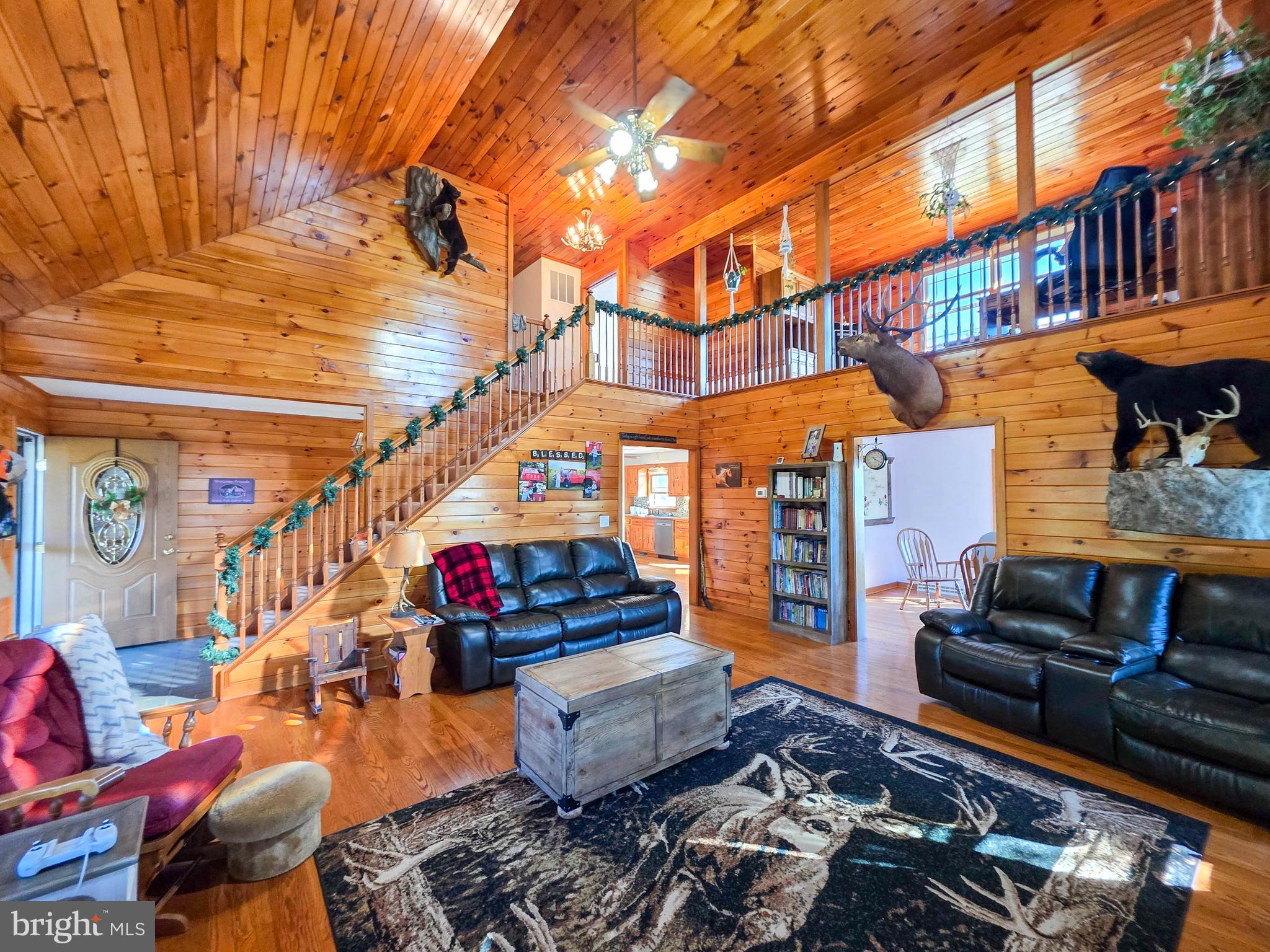 WOW!  Charming 3BR/2BA  7.49  acre farmette in a peaceful rural setting with full mountain views and easy access to I-70. The home features an oversized kitchen,  cathedral ceilings, wood floors, walls, and ceilings for a warm, rustic feel. The spacious main level includes a dining room, laundry room, and primary suite with a walk-in closet and full bath featuring jetted tub, separate shower, and double vanity. Upstairs offers two additional nice sized bedrooms, a full bath, and a bonus office area. The walk-out basement includes a 2-car garage and large storage space. Outbuildings include a 30x50 shop/garage , an insulated kennel with electric and water (Garage and Kennel metered  separately from house), run-in shed, and multiple fenced pastures. Ideal setup for animals or small farm operation. Recent Updates: Roof, siding, and windows (≈8 years), HVAC (≈2 years), blacktop driveway (≈3 years), fencing (≈3 years). This is a move-in-ready property with the perfect mix of privacy, functionality, and accessibility!