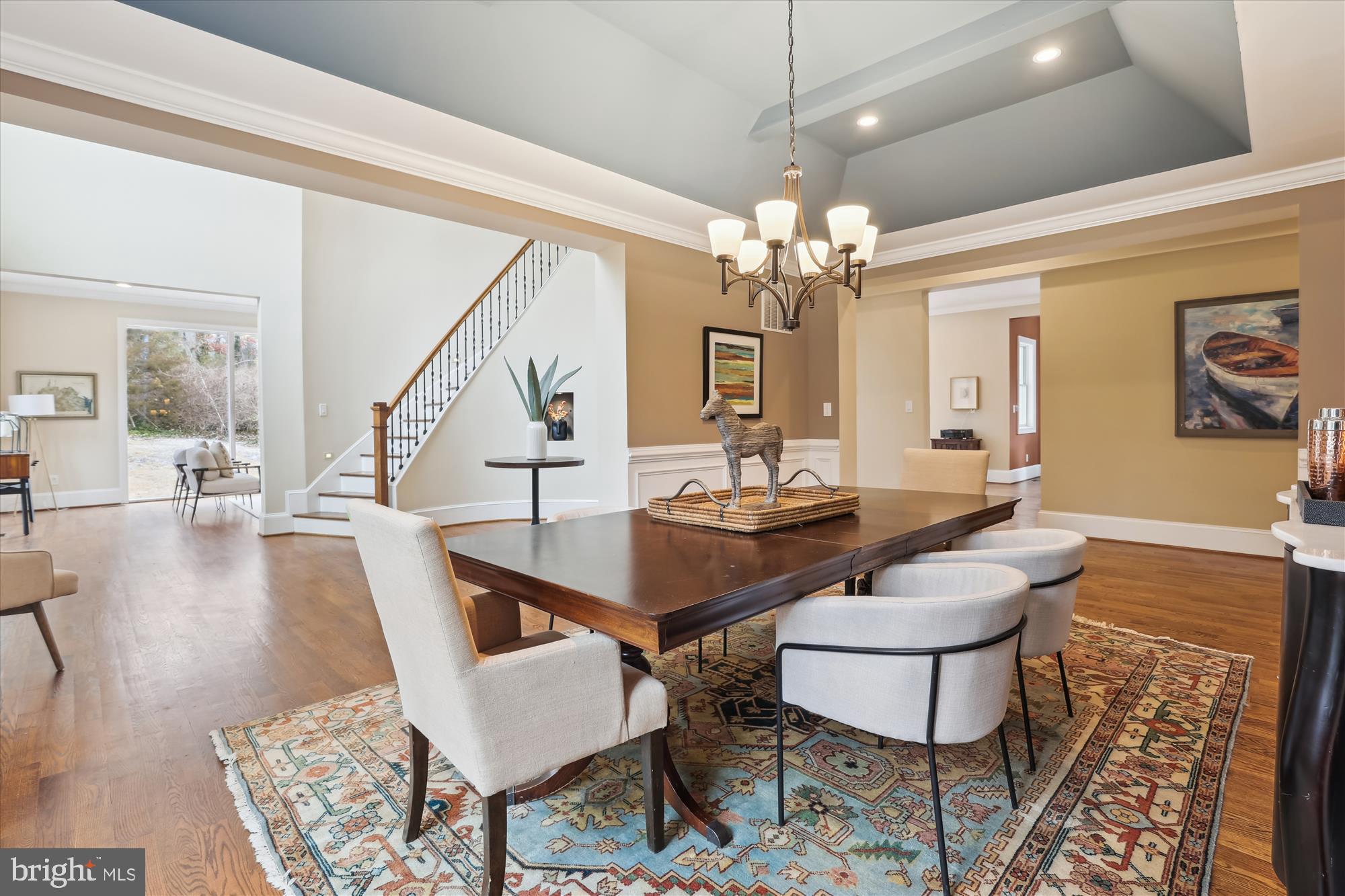 This stunning 6,100 square-foot home is set in a breathtaking natural landscape, with expansive windows that flood each room with natural light. Featuring five generously sized bedrooms, each with its own spa-inspired en-suite bath, walk-in closet, and Juliet balcony, this home offers an unparalleled level of comfort and luxury. Perfect for multi-generational living, one of the en-suite bedrooms is conveniently located on the main level. The fifth bedroom is incredibly adaptable, making it an ideal space for a home office, artist's studio, game room, or any other creative vision.

The home effortlessly combines luxury with practicality, boasting exquisite moldings, tray ceilings, and hardwood floors throughout. Entertaining is a breeze with a formal dining room spacious enough to seat 12+, while the formal living room’s floor-to-ceiling windows frame serene views of the surrounding nature, creating a peaceful and inviting ambiance.

A highlight of the home is the expansive family room, which features soaring ceilings, two-story windows, and a cozy gas fireplace that adds warmth and charm. Step outside onto the Trex deck, which leads to a beautiful stone patio and relaxing hot tub, ideal for enjoying the outdoors.

The chef’s kitchen offers plentiful storage, a prep island, and a peninsula perfect for gathering with family and friends. A charming breakfast room adds extra functionality to the space. The main level also includes a convenient mudroom and powder room for added ease.

The lower level boasts a spacious rec room with access to a full bath offering even more living space. 
This home offers a two car garage plus a large recreational vehicle parking pad that accommodates a 40-foot RV.

This home feeds into Waynewood Elementary School and is just a few blocks to the Potomac River, the GW Parkway and bike trails. It is conveniently located just minutes from the Metro (4.2 miles), Old Town Alexandria (5.3 miles), National Harbor (6.7 miles), and Washington, D.C. (14 miles).  Don’t miss this exceptional lifestyle opportunity.
