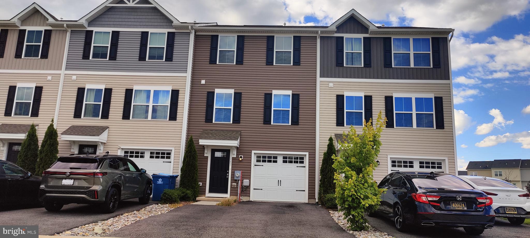 Welcome to our listing at 1047 Wickersham Way in Hyatts Crossing, Middletown. This beautiful three-bedroom, 2.5-bath interior unit townhouse is less than five years old and has all of the comforts you're sure to love.  You can see from the street that this home has been well cared for. As you enter at ground level there's a one-car garage accessible from the inside and a bonus room on the first floor that walks out into the backyard.  On the main floor, you've got tasteful neutral composite flooring throughout, a modern open-concept kitchen, living room, and dining room combination.  The kitchen is great for entertaining and is set up with a central island and stainless steel appliances.  The upper floor has a primary suite with walk-in closet, an en suite bath, two generous secondary bedrooms, an upstairs laundry, and a full hall bath.  Pair all that with a full professional cleaning and a paint refresh, and you have got an attractive, affordable home that is ready to move right in and start enjoying.