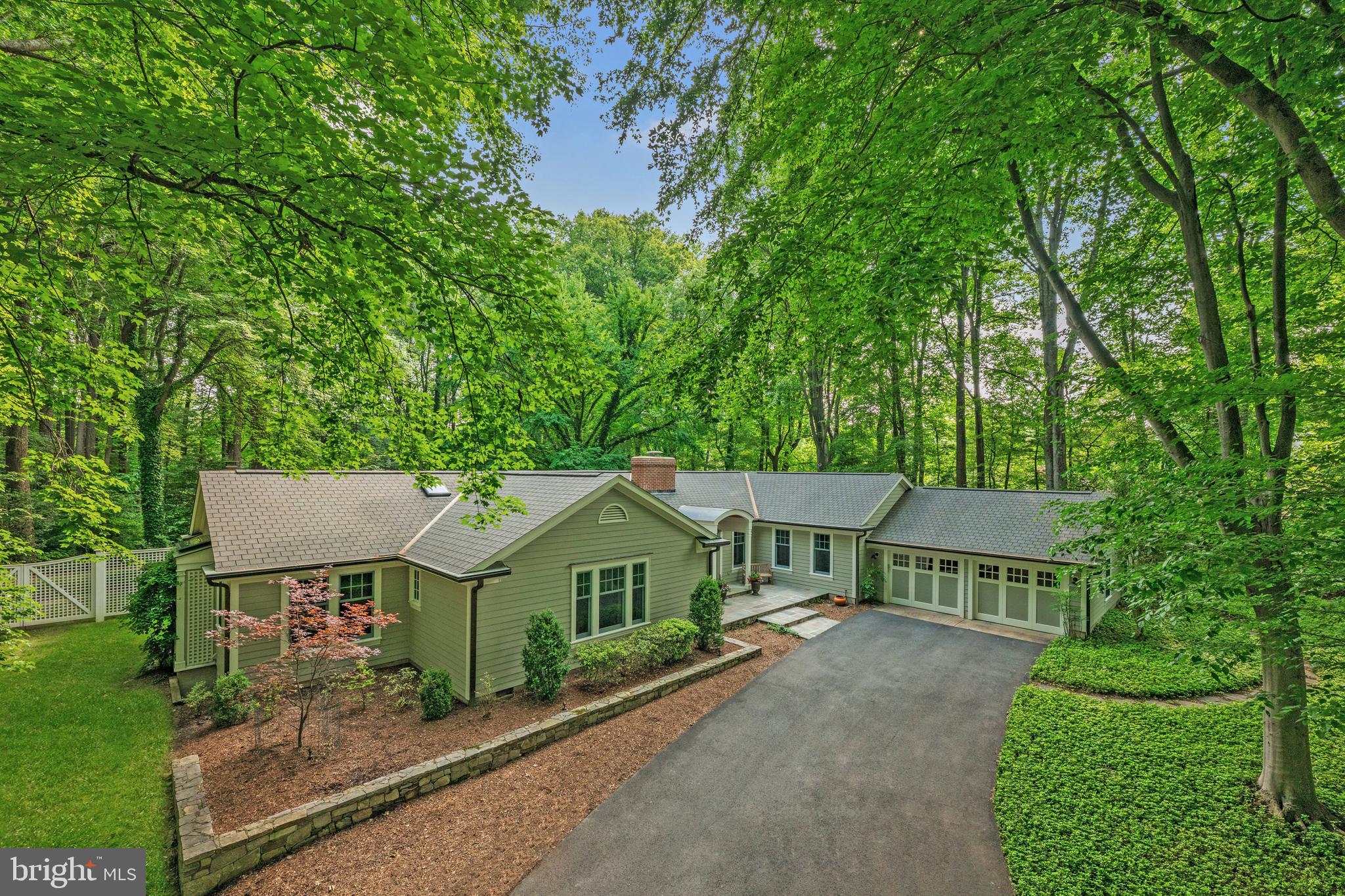 Step into the embrace of 1110 Kelso Road, Great Falls, a New England style treasure that radiates warmth and craftsmanship. Perched on a private 3-acre lot and surrounded by towering trees, the home is in an ideal close-in location for easy commutes to Tysons, McLean, Reston, and Downtown D.C. Tastefully remodeled over the years by its current owners, this home has over 5,700 square feet across two levels and is a haven for those who crave the ease of main-level living paired with vibrant outdoor escapes. The main level unfolds with nearly 3,847 square feet of light-filled elegance. Spacious principal rooms flow effortlessly, from the inviting living areas to a breathtaking sunroom with a vaulted ceiling, where sunlight dances through every season. Two wood-burning fireplaces cast a cozy glow, and walls of glass doors facing the wooded lot beckon you to step outside to extraordinary outdoor spaces that feel like an extension of the home itself. The primary suite, nestled in a quiet wing, is a retreat within a retreat—imagine unwinding in a spa-like bath, spacious shower under a skylight, curling up in the intimate sitting room, or stepping through double French doors to a covered patio deck anchored by an outdoor stone fireplace. Three additional bedrooms (one currently used as an office), two full baths, and a convenient laundry room round out this level. Downstairs, the lower level transforms into the heart of entertainment and family life, with a versatile recreation room, an expansive game and exercise room. A full bath and ample storage keep everything tidy and accessible, ensuring this space is as practical as it is fun. Major commuter routes, Dulles International Airport and Metro’s Silver Line are just a short drive away. Yet, as you return to 1110 Kelso Road, the world fades away, leaving only the peace of your private sanctuary. This isn’t just a house—it’s the home you’ve been dreaming of. Come, make it yours.