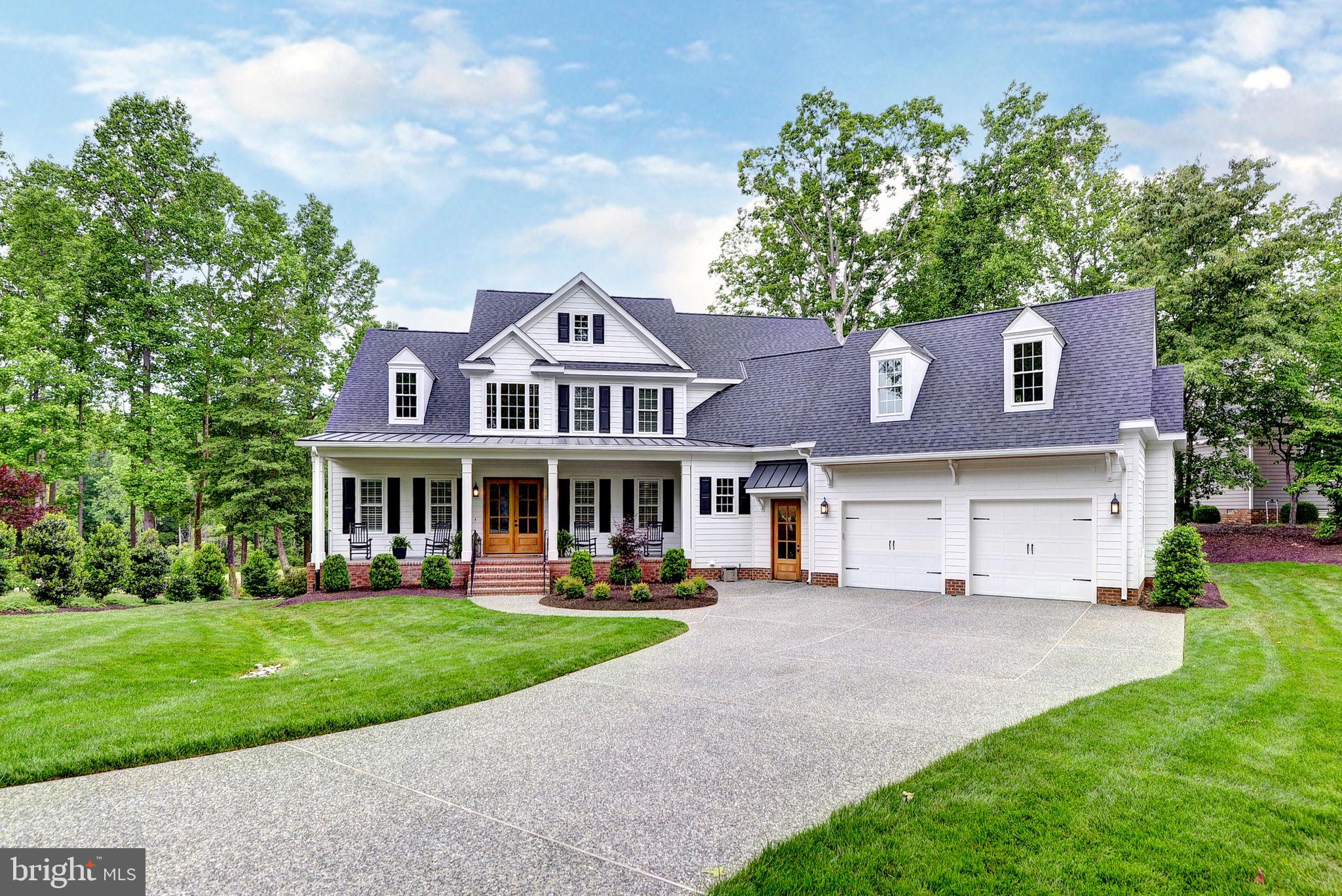 Welcome to your new custom dream home on the 5th hole of the famed Blue Heron course in Ford’s Colony, Williamsburg’s premier gated golf community. This stunning white modern farmhouse features soaring 10' ceilings, a chef’s kitchen with stainless steel Wolf range, dual ovens & dishwashers, and extra wide built-in refrigeration columns. Entertain with ease in the Keeping Room with custom bar, Sonos sound system, and a screened Trex porch with stone fireplace. The spa-like primary suite boasts dual vanities, soaking tub, and a huge luxury tiled shower. Every bedroom offers an en-suite bath and huge closet. Custom trim throughout, two laundry rooms, mudroom with cubbies off spacious garage, and luxury finishes throughout make this home as functional as it is breathtaking.