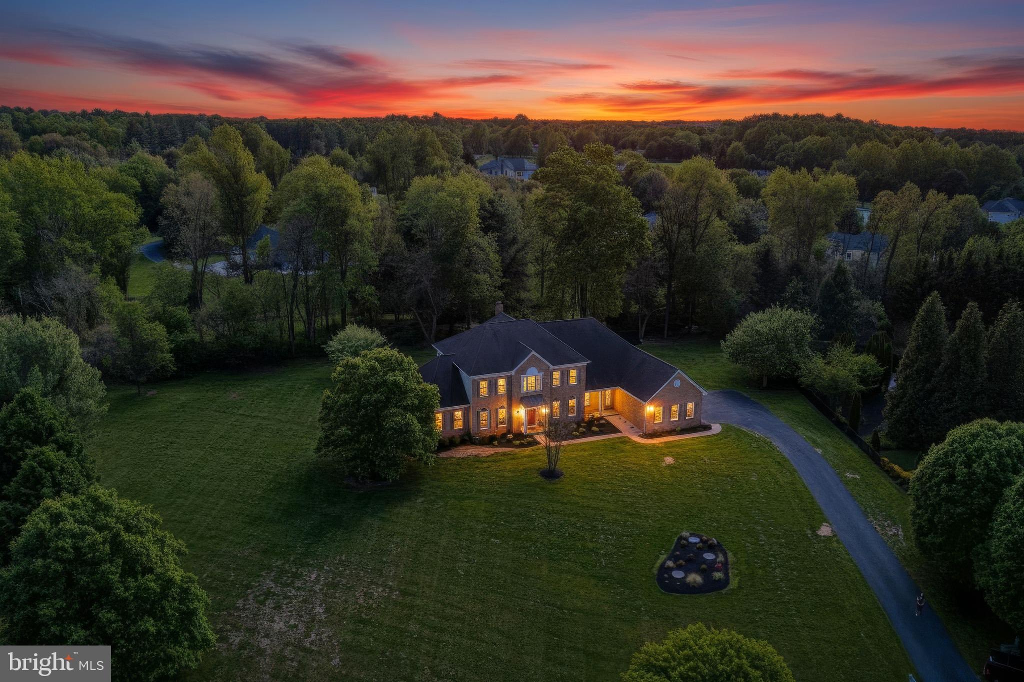 Extraordinary Luxury Estate on 1.4+ Secluded Acres. Welcome to this extensively renovated, move-in-ready 5-bedroom, 6-bathroom estate. This rare, private retreat blends elegant architecture with modern luxury. 
Awesome Main-Level Living: Features a 2-story open foyer with dramatic curved walls and staircases, and a convenient main-level suite with a new full bathroom.
Chef’s Kitchen: The heart of the home boasts a massive waterfall-edge island with an extra prep sink, premium water filtration, abundant soft-close cabinetry for extra storage, updated appliances, and a high end FOTILE range hood.
Ultimate Privacy & Outdoor Living: South facing rear orientation for optimal natural light, professionally landscaped yard, brand-new deck, a welcoming brick front porch, and a second covered porch off the kitchen.  
Private Sanctuaries: Upstairs offers 4 spacious bedrooms, each with its own full en-suite bathroom. The spectacular primary suite boasts tray ceilings, a relaxing sitting room, and a new spa-like bathroom.
Versatile Lower Level: The newly finished basement features 9’ ceilings, an oversized recreation space, a work/sleep area ideal for remote work, and a 6th full bathroom.
Garage & Tech: 3-car side-entry garage equipped with a ready-to-use EV charger.
This gorgeous home is better than new and ready for you to enjoy.