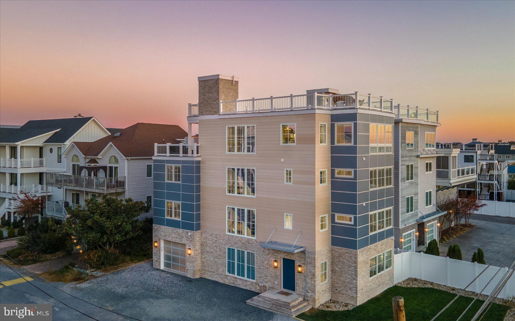 Introducing 40 Beach Avenue – a modern masterpiece on the ocean block of private North Indian Beach. This new home, crafted by Lane Builders in 2024, is being sold furnished and features 7 bedrooms, 7.5 baths, and 4200+/- square feet of finished indoor space spanning across 4 luxurious levels. What’s more, you’ll enjoy breathtaking views of the Rehoboth Bay and the Atlantic Ocean from your expansive Duradek rooftop deck. Every inch of this home has been customized to perfection, including custom millwork throughout, multiple wet bars, customized bathroom and kitchen cabinetry, and soft close cavity pocket doors. An upgraded lighting and electronics package by Overture Ultimate Home Electronics includes low voltage recessed lighting throughout, customizable keypads, Paradigm ceiling speakers on the fourth level, LED/OLED Sony TVs, and more. An elevator services every floor from the garage to the rooftop deck. The first level of the home features porcelain tile flooring throughout, a bedroom, bathroom with tiled shower, rec room, and wet bar with custom tile. A nod to the history of the North Indian Beach community is incorporated into the brick wall of the entryway – reclaimed from the original beach cottage that once stood on this lot. The second and third level each have 3 bedrooms with 3 ensuite bathrooms, a washer and dryer, and a tech station. The primary bathroom on the third level is wheelchair accessible with a zero-threshold shower. The living and dining area and the gourmet kitchen are on the fourth level of this state-of-the-art home – all with views of the Rehoboth Bay. The kitchen is a chef’s dream, featuring Vadara Quartz countertops with built-up edges, an 8-burner Wolf range, XO range hood, pot filler, Ruvati kitchen sinks, KitchenAid stainless steel refrigerator, microwave, wall oven, two dishwashers, a butler’s pantry and a full wet bar with ice maker, wine cooler and beverage refrigerator. There is also a powder room on this level. Steps from the kitchen is the fourth level Duradek deck with outdoor grill, refrigerator, and honed granite countertops. Follow the stairway to the best part of all – the rooftop deck with stunning views of Rehoboth Bay, Dewey Beach, and the Atlantic Ocean. With the unique allowance in North Indian Beach to build to a height of 42 feet, this home has an impressive advantage above and beyond those in neighboring Indian Beach and Dewey Beach, where 35 feet is the max. The rooftop deck has a stub for a future fire pit and wiring for outdoor speakers. It is also structurally sufficient to hold a hot tub. The garage in this home is not to be overlooked. It includes one of the three laundry stations in the home, sink with granite countertop and custom cabinetry, a drying rack, and True brand commercial-size ice machine to make filling up your beach cooler a breeze. It also houses the tank for your fire suppression system and a lead/lag booster pump to ensure consistent water pressure always flows within the home. This unbelievable home is being offered fully furnished and turn-key with high-end furnishings from Universal, Lexington, Fairfield Chair, John Thomas, Braxton Culler, Creative, and Legacy. All design work and furniture selections were done by Barbara Anderson Design and truly capture that high-end, coastal feel. Located in the intimate oceanside enclave of North Indian Beach, you’ll have access to a private, guarded beach and neighborhood security patrol. This community allows one-week rentals, meaning this property isn’t just an incredible coastal getaway for you as a primary or secondary home but also a valuable rental opportunity with the potential for $15,000 per week during prime summer weeks. Walk to everything Dewey Beach has to offer and then retreat to the calm oasis of North Indian Beach when you call 40 Beach Avenue your home away from home! Be sure to view the Drone Video and 3D Virtual Tour!