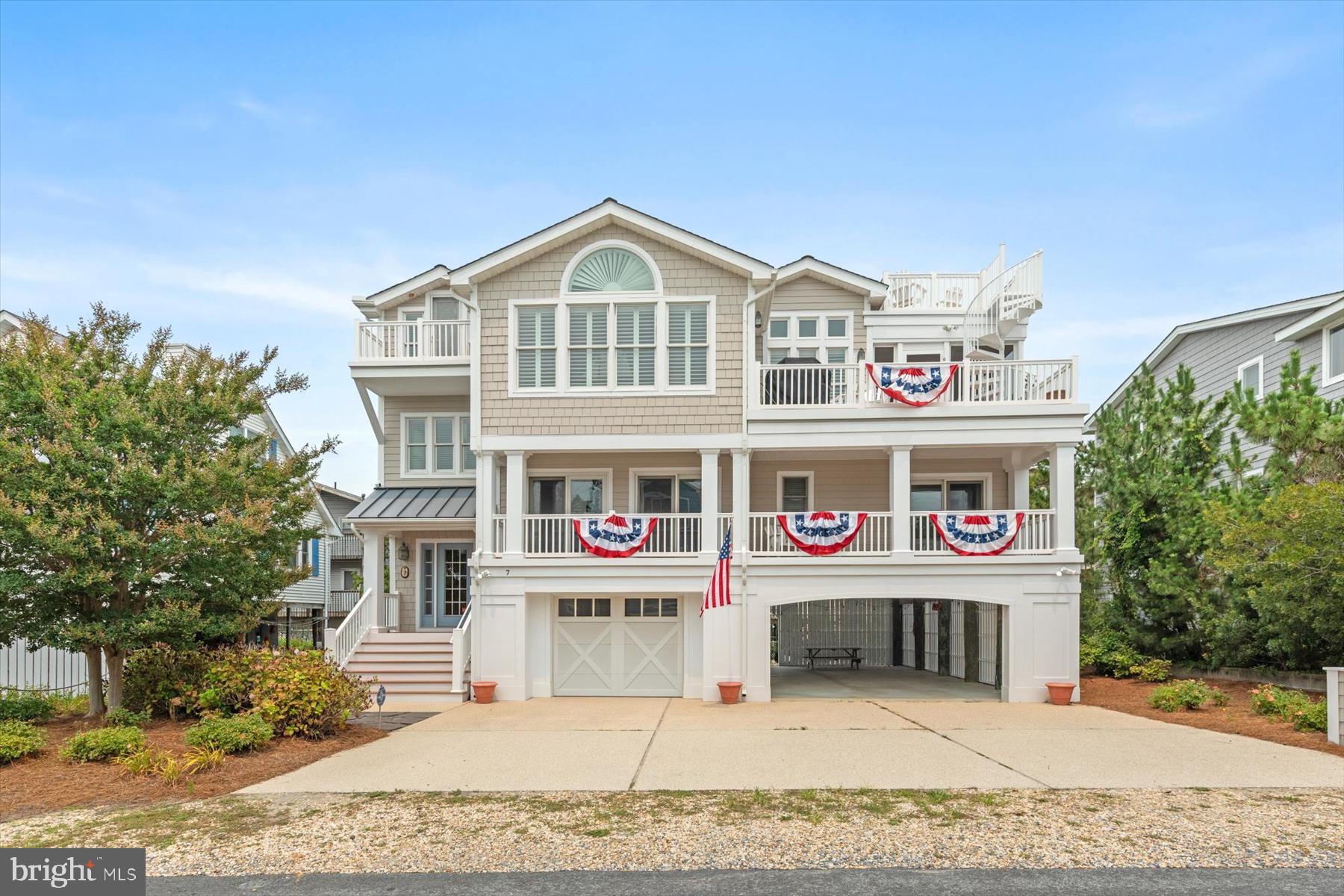 Perfectly positioned just four lots from the ocean and only steps from the sand and surf, this exceptional coastal residence offers luxurious beach living in one of South Bethany's most desirable locations. Thoughtfully designed with an inverted floorplan to maximize natural light and capture glimpses of the ocean, the home is enhanced by an elevator servicing every level and exquisite custom millwork throughout. The upper level is dedicated to the home's impressive living spaces, where a dramatic vaulted ceiling and a floor-to-ceiling stone gas fireplace anchor the expansive great room. The open-concept design flows seamlessly into the dining area and gourmet kitchen, beautifully appointed with custom cabinetry, subway tile backsplash, stainless steel appliances including a gas range with hood vent, and a large center island with seating. Just beyond, a spacious screened porch and adjoining sun deck create an ideal setting for entertaining or relaxing, with stairs leading to a rooftop deck offering elevated coastal views. Also on this level is the spacious primary suite featuring a beautifully appointed ensuite bathroom with dual vanities and a walk-in shower accented by floor-to-ceiling tile, along with a convenient powder room and a charming elevated reading nook or home office. The lower level is designed for comfortable gatherings and overnight guests, offering a generous family room enhanced by a tray ceiling and elegant wainscoting, a dedicated laundry room, four spacious guest bedrooms, and two full bathrooms. This level also opens to a welcoming covered front porch, providing another inviting outdoor living space. On the ground level, a large storage room offers plenty of space for bikes and beach gear, while two outdoor showers make rinsing off after a day at the beach effortless. The expansive covered area provides exceptional flexibility for recreation or covered parking for up to five vehicles, complemented by room for four additional cars in the driveway. Ideally located in South Bethany, renowned for its wide, lifeguarded beaches and relaxed coastal charm, this exceptional property is just a short drive from downtown Bethany Beach, where boutique shopping, acclaimed restaurants, and the boardwalk await.