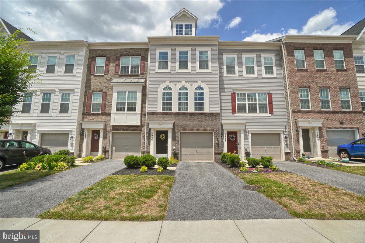 4th of July Firecracker in Jefferson Place!   Don’t miss this beautifully decorated upgraded townhome with a one car garage, gleaming hardwood flooring in the foyer leads down the hall to the office/family room or possible 3rd Bedroom with a ½ bath, walk out the sliding glass door to the concrete patio with a large common area of grass.  The main level welcomes you to an open living concept with tons of natural light, hardwood floors, recessed & pendant lighting, and a sliding glass door leading out to the trex deck with mountain views.  The gourmet kitchen features granite countertops, an abundance of white cabinetry, stainless steel appliances (microwave, refrigerator w/ice maker, dishwasher, and gas stove), an oversized large island is perfect for entertaining. Off the kitchen is a spacious living room with gorgeous Palladian windows, and a dining/eat in area. The third-floor features 9ft ceilings, the primary suite with an ensuite bathroom (double sinks, ceramic flooring and oversized ceramic shower), a laundry room with newer washer/dryer that conveys.  The 2nd bedroom offers an ensuite with a tub/shower with ceramic flooring/tub/shower surround.  Community amenities include pool, basketball, tennis & volleyball courts, gym, clubroom and dog park! Great commuter location; convenient to routes 70, 40, 270. Close by shopping & restaurants.  Come Take A Look!