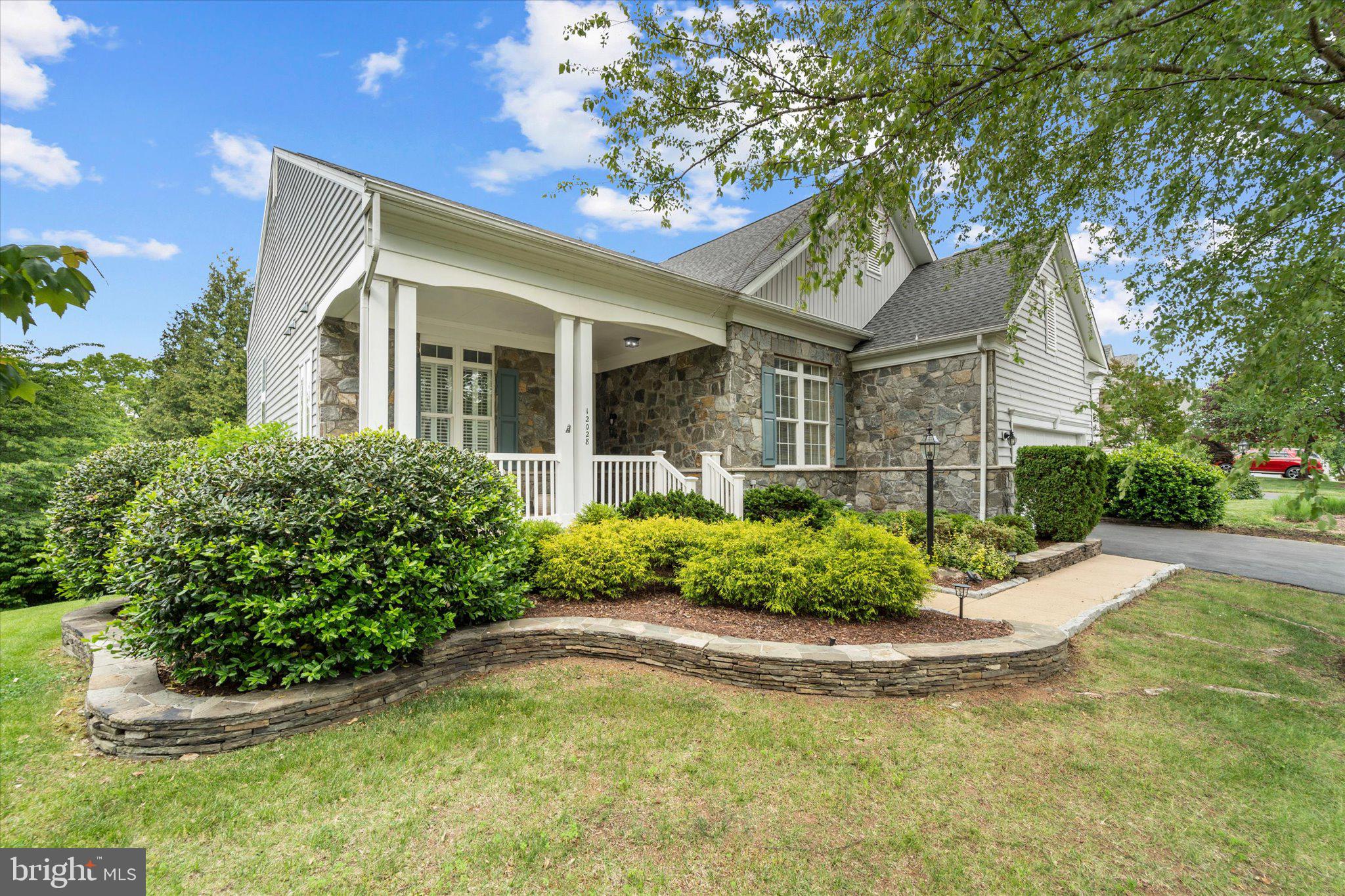 Welcome to 12028 Rutherglen Place, one of the largest and most versatile floorplans in the highly sought-after 55+ community of Dunbarton at Braemar in Bristow, Virginia. Offering over 3,500 square feet of beautifully designed living space across two spacious levels, this exceptional home combines comfort, flexibility, and resort-style community living.

Designed with both everyday convenience and entertaining in mind, the home features a spacious main-level primary suite, generously sized secondary bedrooms, multiple living and gathering spaces, a large recreation room, dedicated office/flex space, and abundant storage throughout. The thoughtful layout provides ideal separation for guests, hobbies, multigenerational living, or simply enjoying extra room to spread out and relax.

The heart of the home is the open-concept kitchen, breakfast nook, and family room, creating a warm and inviting space for gatherings and daily living. The kitchen is equipped with stainless steel appliances, including a built-in microwave, range, dishwasher, center island, breakfast area, and abundant cabinetry, blending style and functionality with ease. Large windows and serene wooded views bring natural light and tranquility into the home, while the deck, and outdoor living areas provide the perfect setting to enjoy morning coffee or peaceful evenings surrounded by nature.

Built in 2004, this beautifully maintained traditional-style detached home offers four spacious bedrooms and three full bathrooms. Elegant hardwood flooring, plush carpeting, and ceramic tile create a warm and inviting atmosphere throughout. Additional highlights include custom built-ins, ceiling fans, generous closet space, and tasteful window treatments.

The spacious primary suite serves as a private retreat, complete with walk-in closets and a luxurious en-suite bath featuring a jetted soaking tub and separate walk-in shower. The finished lower level offers incredible flexibility with additional bedrooms, recreation space, office space, and storage areas rarely found in homes within the community.

Situated on a beautifully landscaped 0.28-acre lot backing to mature trees and woods, the property offers both privacy and peaceful outdoor living.

Dunbarton at Braemar provides an exceptional active adult lifestyle with amenities that include an indoor pool, fitness center, clubhouse, game room, hot tub, pickleball and tennis courts, putting green, walking paths, and a full calendar of social activities. Residents also enjoy low-maintenance living with community services that include cable TV, high-speed internet, and snow removal.

With an attached garage, outdoor spaces and one of the community’s largest floorplans, this home is more than just a residence — it’s a lifestyle opportunity designed for comfort, convenience, and connection.

Don’t miss your chance to own one of Dunbarton at Braemar’s most spacious and desirable homes. Schedule your private tour today!