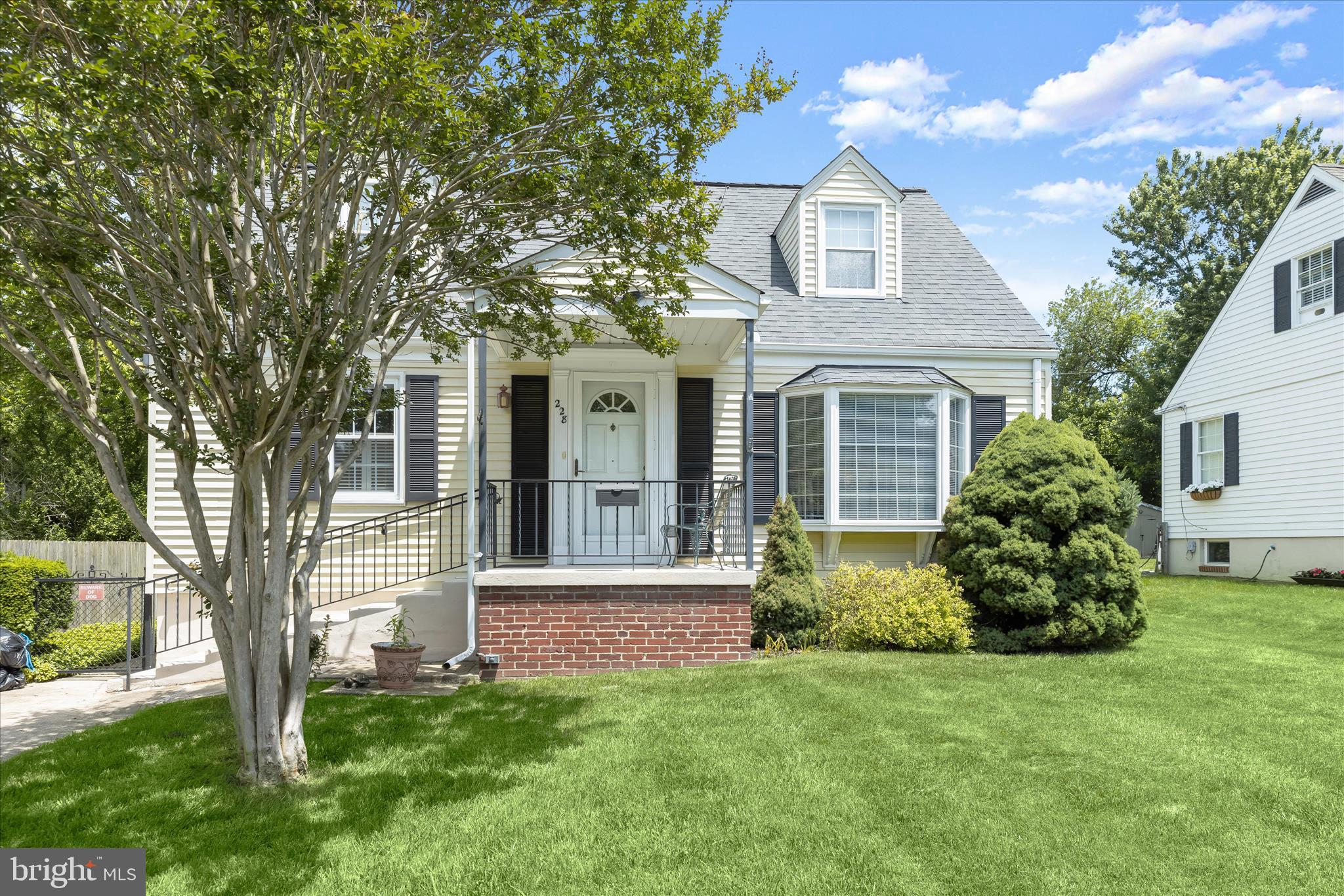 Lovingly maintained and full of character, this 4-bedroom, 1.5-bath Cape Cod is tucked away on a peaceful cul-de-sac near historic Lutherville. Thoughtfully landscaped grounds create a welcoming first impression and lead you inside to the main living level, where a sun-filled living room with a charming bay window flows seamlessly into the dining room, creating an inviting space for everyday living and entertaining. Just beyond, the bright and airy three-season sunroom serves as a relaxing retreat, featuring walls of sliders, a vaulted beamed ceiling, and a skylight that fills the space with natural light. From here, enjoy views of the level, fenced rear yard complete with a patio, storage shed, mature trees, and attractive landscaping.
The kitchen offers gas cooking and presents a wonderful blend of timeless mid-century style and future potential. Original wood cabinetry showcases the craftsmanship and warmth of the era, providing an appealing backdrop for those who appreciate vintage design or an inspiring foundation for a thoughtful update. The home's mid-century influences continue throughout the main level, where two bedrooms and a full hall bath contribute to its enduring charm and provide plenty of inspiration for creating a space that reflects your personal style. Upstairs, two additional bedrooms feature charming dormer windows and built-in storage, adding both character and functionality.
The living space extends to the lower level, where an expansive recreation room showcases beautifully preserved mid-century craftsmanship. Rich knotty pine paneling wraps the walls in warm wood tones, while a striking beamed ceiling adds architectural interest and depth. At the center of the room, a classic brick fireplace creates a cozy focal point, flanked by extensive built-in cabinetry and open shelving that provide exceptional storage and display space. A dedicated workshop offers the perfect area for hobbies, woodworking, crafting, or home projects, adding flexibility and functionality to the lower level.
Thoughtfully designed custom bench seating creates an inviting nook for reading, conversation, or relaxing by the fire. Filled with warmth, character, and authenticity, this remarkable space offers a rare opportunity to embrace its timeless appeal or incorporate your own design vision while preserving the distinctive mid-century charm that makes this home truly special.

Note:  Select interior photos have been virtually staged.