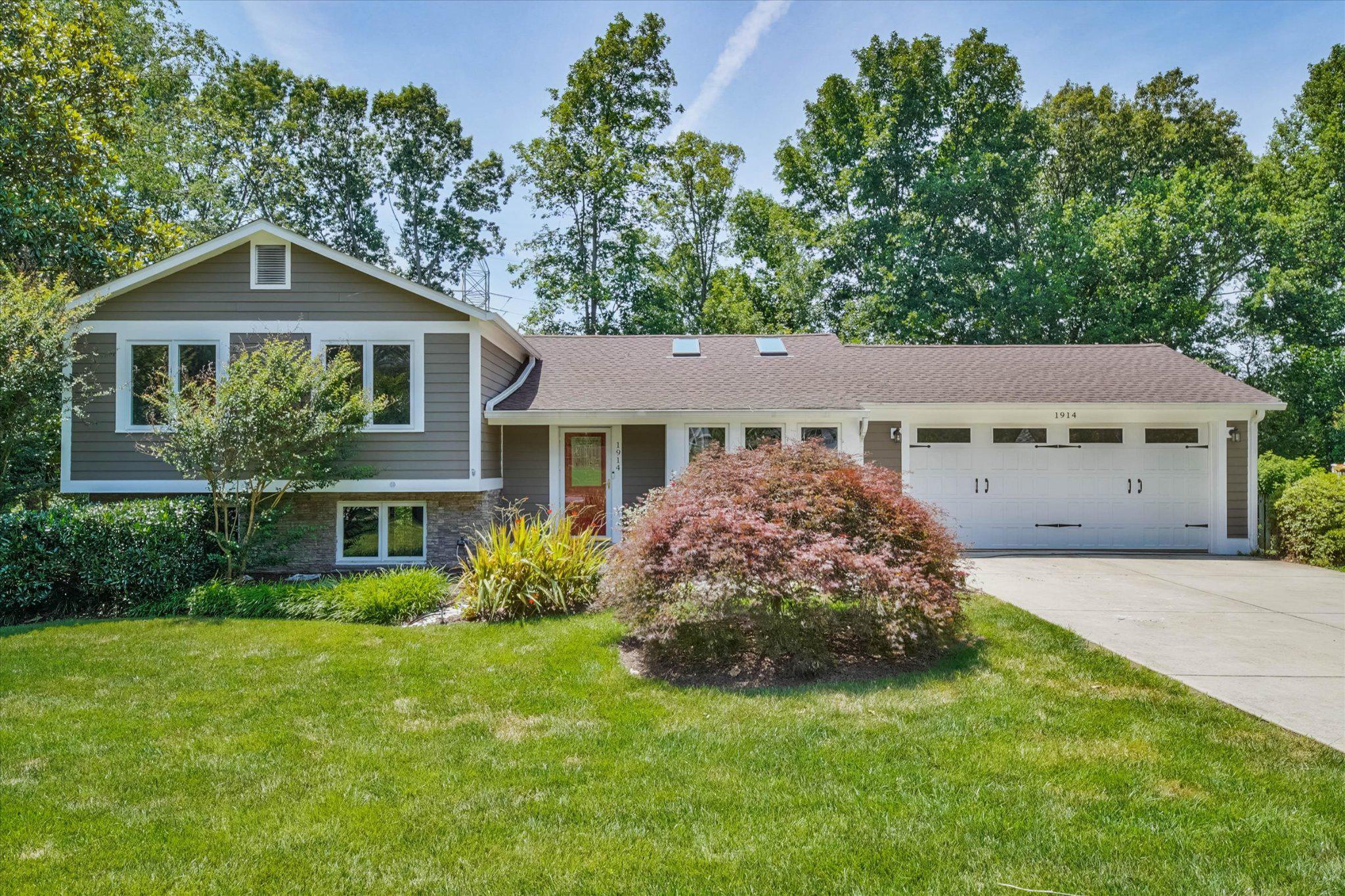 OPEN SAT + SUN, 2-4PM. JUST LISTED! Beautifully renovated and thoughtfully maintained, this exceptional home offers quality craftsmanship and timeless finishes throughout on a generous 0.37-acre lot with beautifully landscaped grounds, mature trees and vibrant perennial gardens. The heart of the home is the renovated kitchen featuring custom Alder wood cabinetry with soft-close drawers, honed Virginia Mist granite countertops, premium appliances, a built-in banquette and strand bamboo flooring. Double sliding glass doors open to a spacious composite deck with modern railings, creating seamless indoor-outdoor living and showcasing spectacular sunset views. The attached two-car garage includes an EV charger and convenient access to both the kitchen and backyard.

The upper level was extensively reimagined in 2014 to create a luxurious owner's retreat complete with a spa-inspired bath, six closets, its own temperature-control system and a Juliette balcony overlooking the backyard. Four bedrooms and three full bathrooms provide comfortable accommodations, while the oversized walk-in laundry room features LG front-load washer and steam dryer units, functional storage, hanging space and thoughtful organization. Strand bamboo flooring extends throughout the upper level, adding warmth and continuity.

The lower levels offer outstanding flexibility with a spacious recreation room featuring brand-new carpet, a fireplace, and walk-out access to the backyard, plus a versatile bonus room ideal for a home office, gym, workshop, hobby space or potential fifth bedroom. Additional improvements include a 2025 HVAC system, approximately five-year-old water heater, abundant storage and dedicated project space with built-in shelving and workbench. Outside, the fully fenced 0.37-acre lot is enhanced by mature landscaping, extensive stonework, terraced gardens, an electrified storage shed, Gutter Guards, a double gate by the garage and private gate access directly to the W&OD Trail. The HardiePlank and stone exterior was freshly painted in 2024, and the roof was replaced in 2024.

Nestled on a quiet double cul-de-sac in the sought-after Tiburon community with no through traffic, this home offers an exceptional blend of privacy and convenience. Enjoy direct access to the W&OD Trail, easy access to the Town of Vienna, Wolf Trap National Park for the Performing Arts, Meadowlark Botanical Gardens, shopping, dining, and major commuter routes including the Dulles Toll Road, Route 123 and Route 7. Zoned for Wolftrap Elementary/Thoreau Middle (effective August 2026)/James Madison High School pyramid, this home also provides the opportunity to experience Vienna's celebrated small-town charm through beloved community traditions including Viva Vienna, Oktoberfest, the Halloween Parade, the Madison Homecoming Parade, summer fireworks and year-round events.